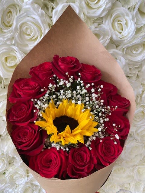 You Are My Sunshine You Are My Sunshine - This beautiful bouquet stars a vivid yellow sunflower encased by a dazzling dozen red roses and sprinkled with baby's breath to set the tone for love, romance, and happiness. This dreamy bouquet is perfect for any occasion.