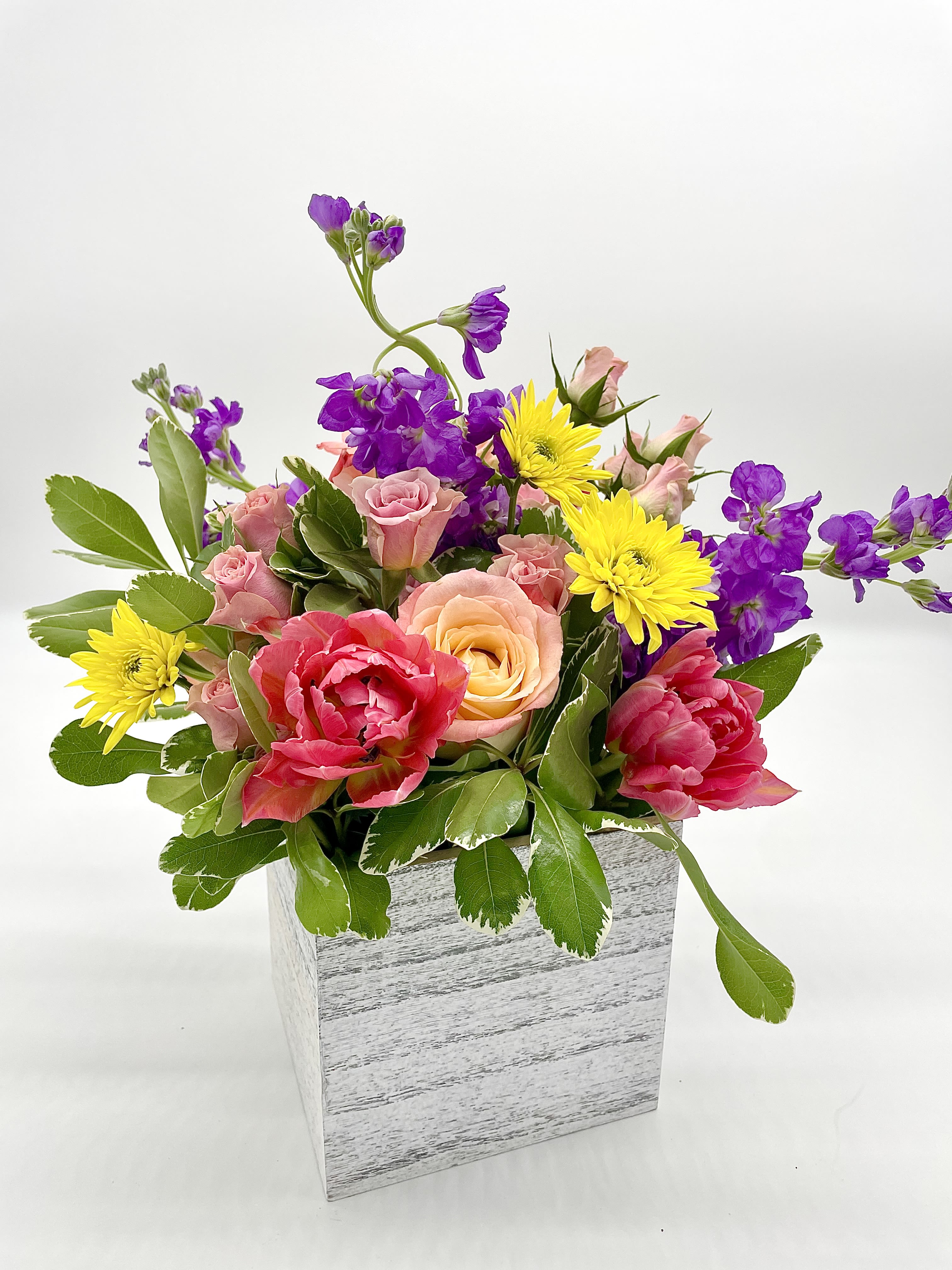 Joyful Garden Joyful Garden - This arrangement evokes the feel of a garden in full bloom as it reflects the cheerful, vibrant colors of the blooms enhanced by the rustic charm of a white wooden vase. Blooms are hand delivered in person to enhance any celebration or a “just because” surprise. Deliveries are done between 10am - 5pm. If the recipient is not home, we will leave the delivery if safe from the elements. We will call or text the recipient and let them know a delivery has been left.