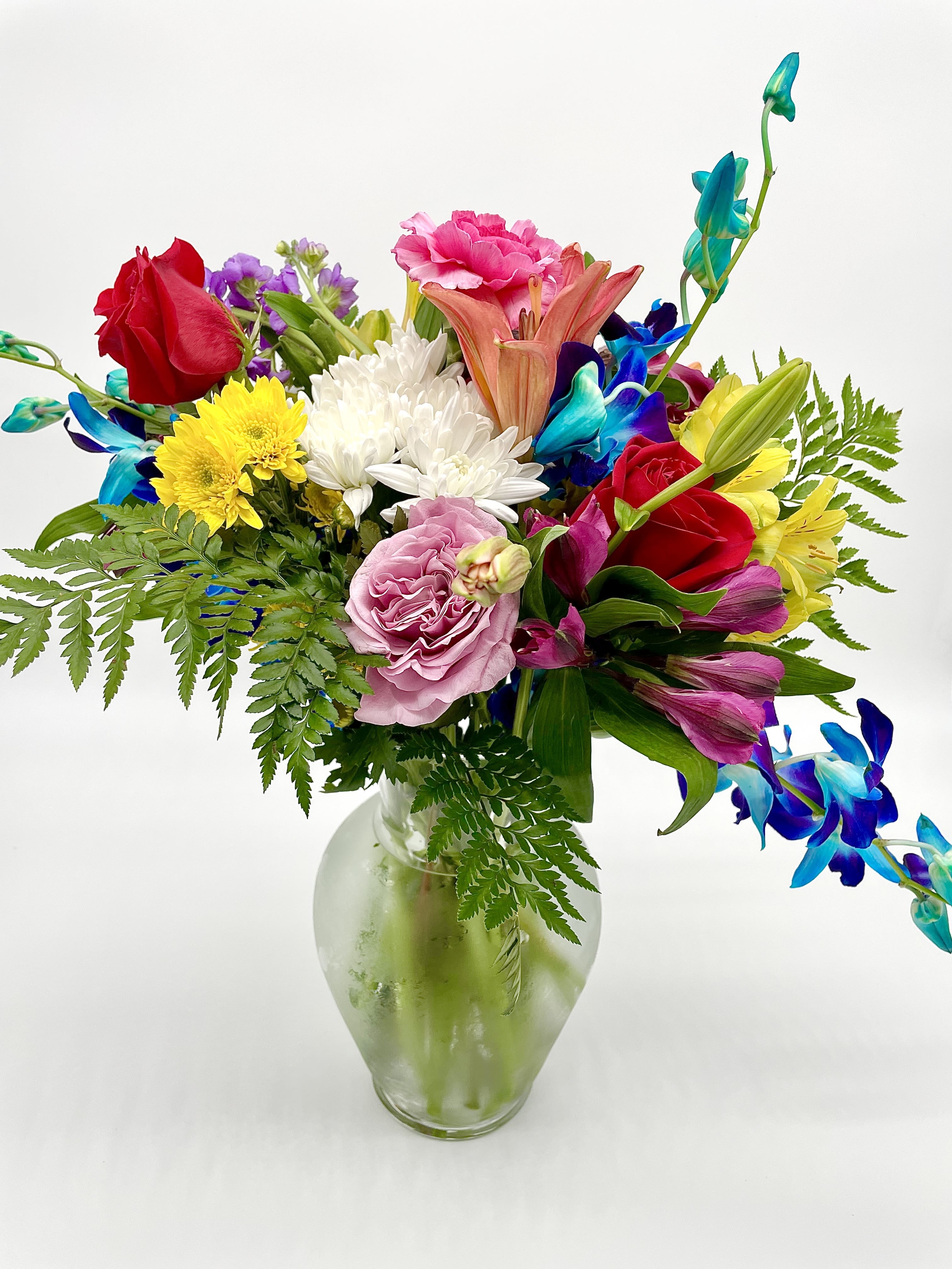 Spring Bliss Spring Bliss - Bring in the spirit of spring, with this cheerful arrangement featuring a blend of colors all coming together to represent the beginning of a new season. All bouquets are arranged by our professional floral design team accented with seasonal filler (i.e. greenery, baby’s breath, etc.) inside an elegant glass vase or gift box. When artistically designed in a clear glass vase arrangement measures approximately 23"H x 18"L. Blooms are hand delivered in person to enhance any celebration or a “just because” surprise. Deliveries are done between 10am - 5pm. If the recipient is not home, we will leave the delivery if safe from the elements. We will call or text the recipient and let them know a delivery has been left.