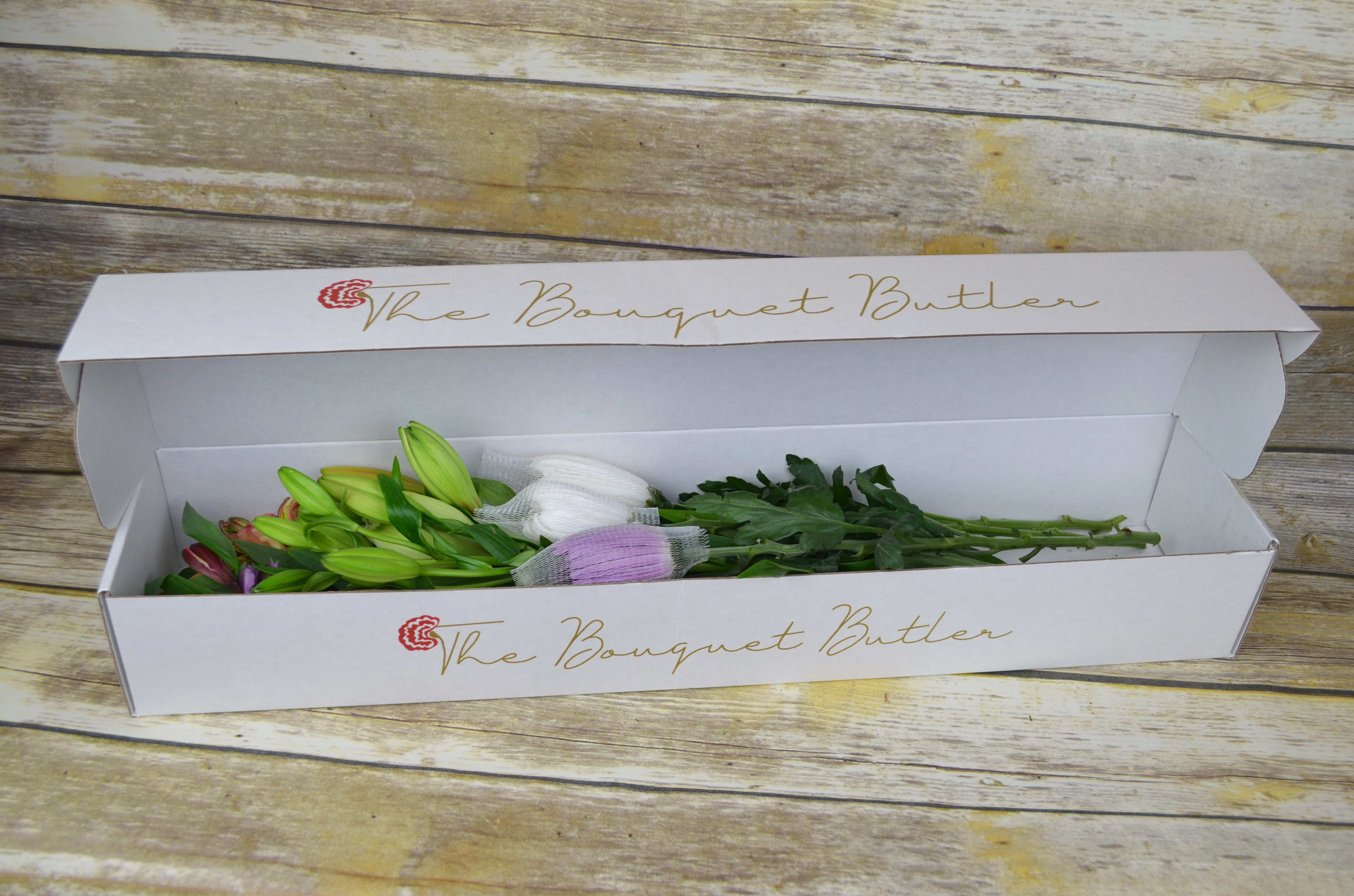 A Taste of Spring - Boxed - Bring spring in no matter what the season with this thoughtful blend of lilies, chrysanthemums, and alstroemerias.  All bouquets are arranged by our professional floral design team accented with seasonal filler (i.e. greenery, baby’s breath, etc.). Blooms are hand delivered in person in a floral gift box. Deliveries are done between 10am - 5pm. If the recipient is not home we will leave the delivery if safe from the elements. We will call or text the recipient and let them know a delivery has been left. 