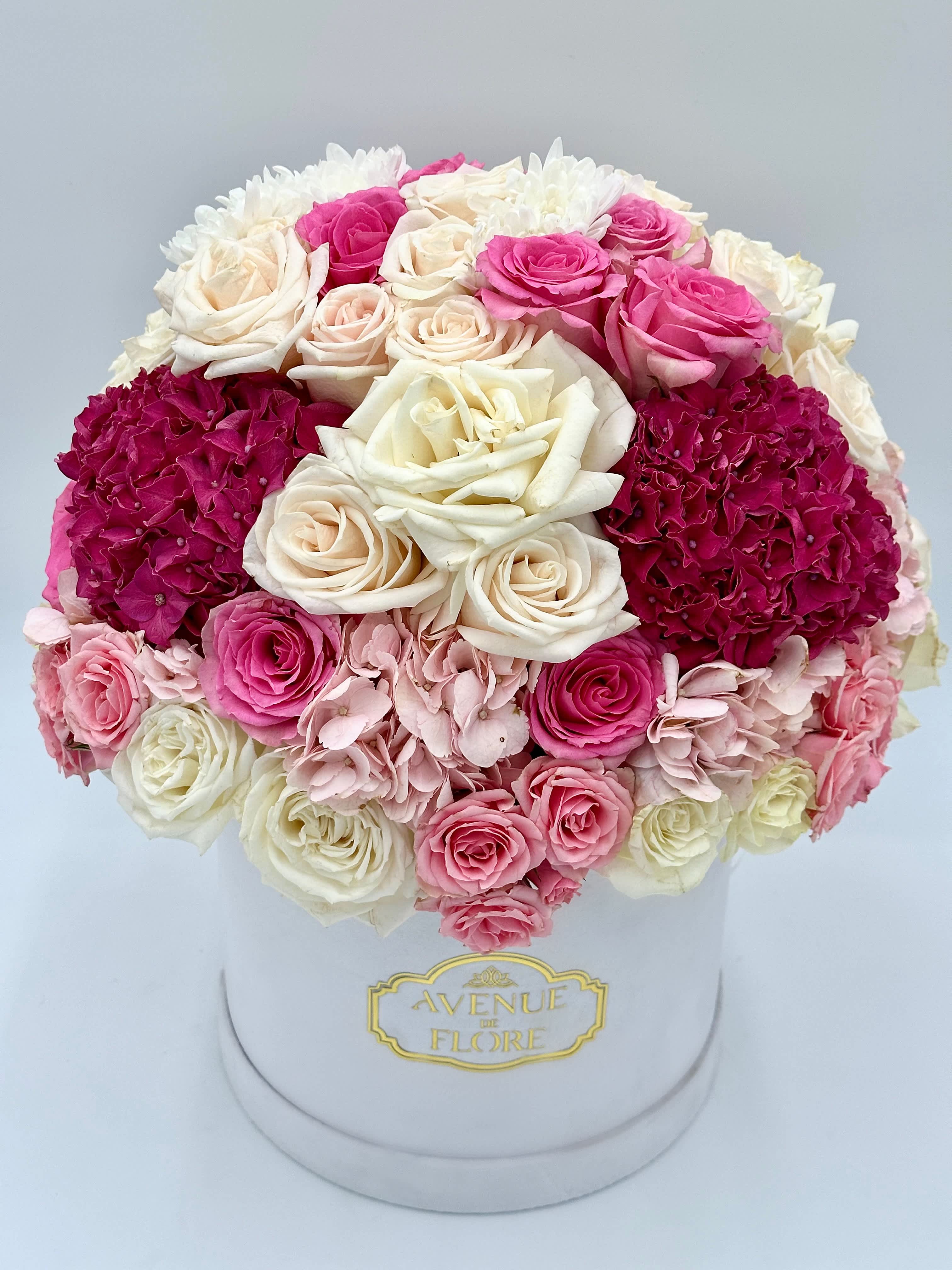 Pink and Ivory Garden - Introducing Pink And Ivory Garden—a captivating flower arrangement that enchants with the timeless allure of delicate pink blooms. Meticulously curated, each petal reveals a soft elegance, capturing the essence of romance and grace. This arrangement is a celebration of femininity and tenderness, where blush hues come together in a harmonious dance of color.  