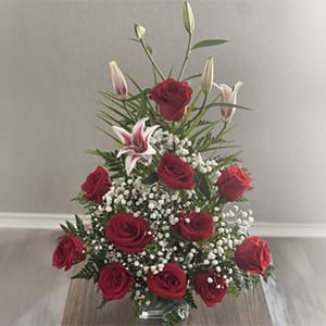 Be My Valentine - This elegant flower arrangement of long stem red roses, gaze star  lilies, baby’s breath flowers, leather leaf fern on a clear square base.