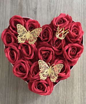 Heart Shape Pink Box With 16 Red Roses - Presenting a captivating heart-shaped arrangement, perfect for the person you love. Displayed are eighteen classic red roses with 3D butterfly stickers. Topped off with a small crown, this arrangement is ready for delivery, ensuring a lasting impression.