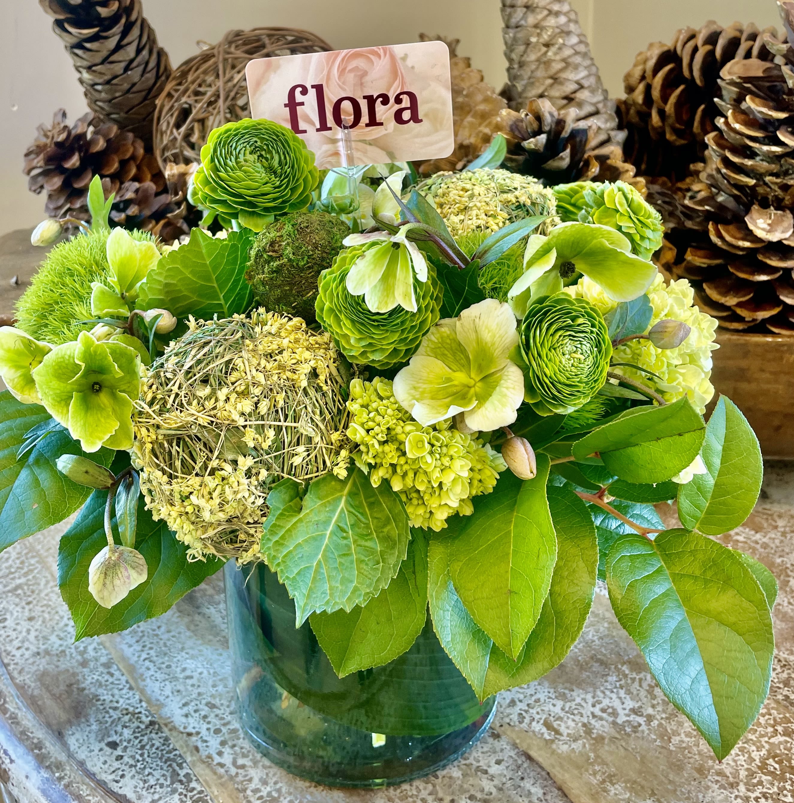 Lucky Spring Lucky Spring - Ranunculus, hydrangea and hellebores in shades of green in a vase.
