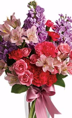 Bursting Passion - Bursting Passion captures your love with lavender stock, pale pink alstroemeria, hot pink spray roses and mini carnations delivered in a glass vase adorned with a pink ribbon. Exceptionally beautiful bouquet for your special love!