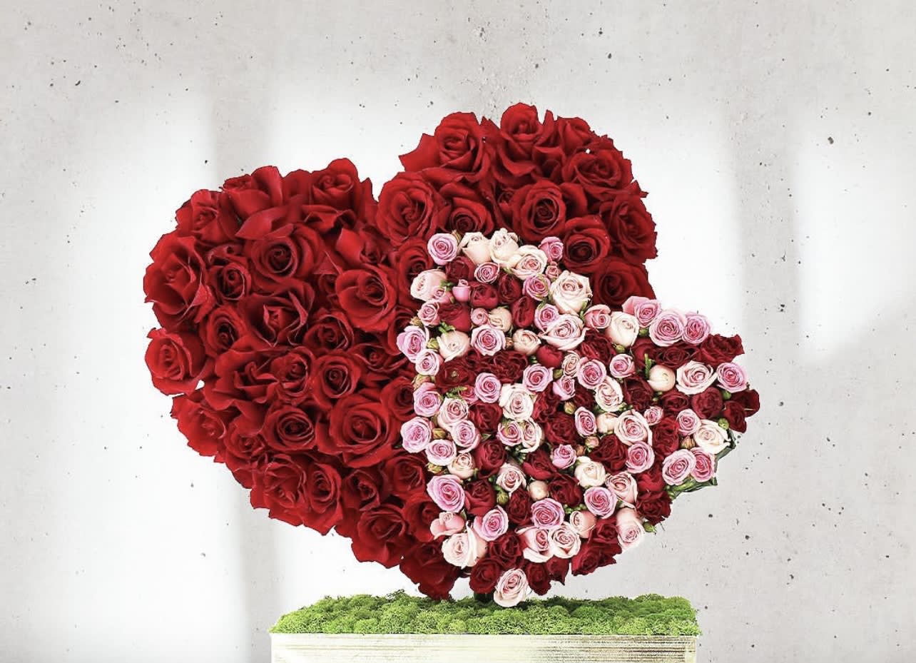 I hold your heart close to mine  - standing hearts blend as one in this beautiful all rose design. Send someone this soulful floral gift and there’ll be no mistaking that you’re holding your heart close to theirs.  Both hearts are made entirely of roses.    Large heart measures approx. 16” Smaller heart measures approx 12”