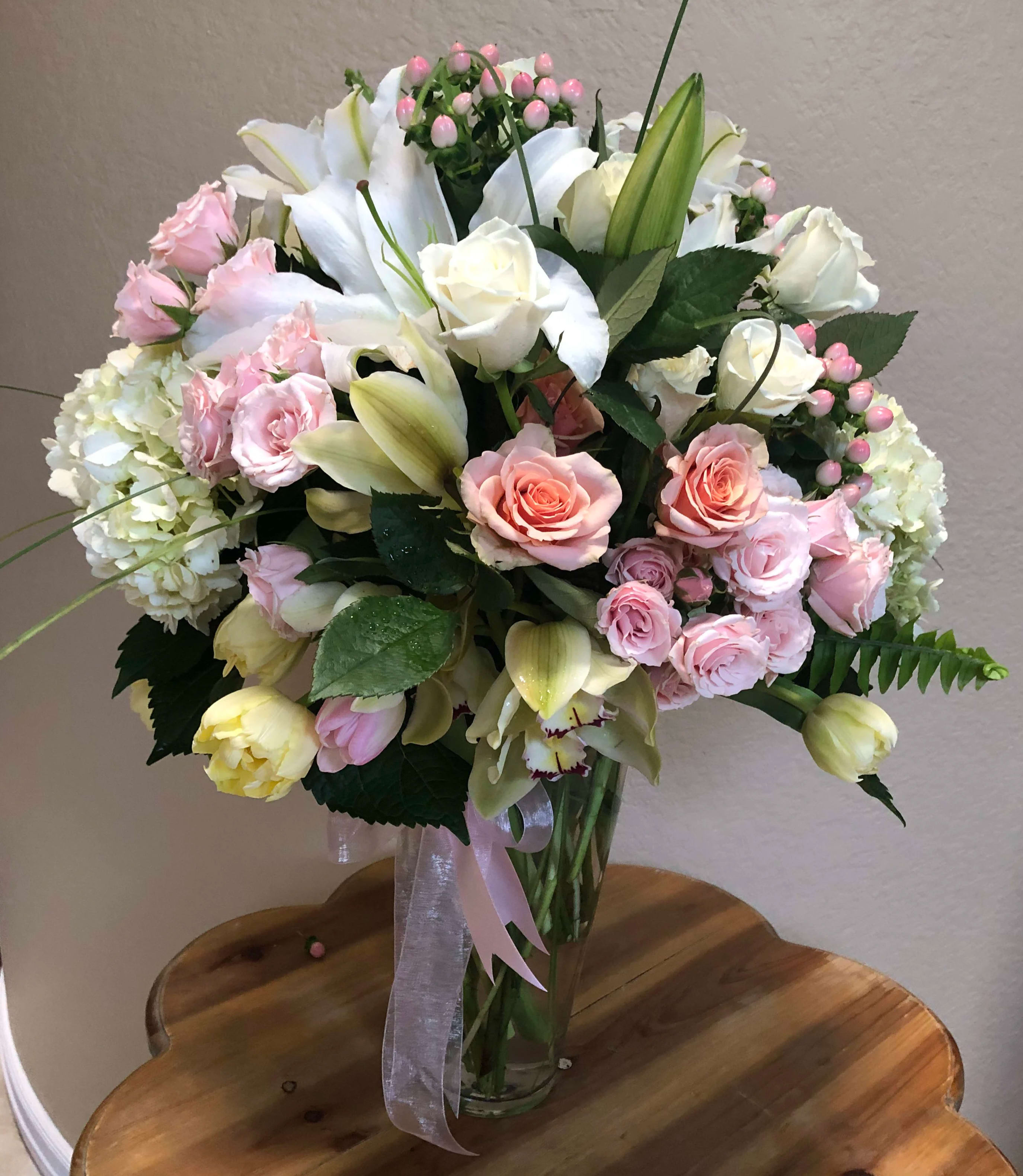 Blush In Bloom Blush In Bloom - A beautiful 360 degrees of flowers in soft hues of pink and ivory, featured in a large glass vase. Flowers include roses, lilies, hydrangea, tulips, and more.