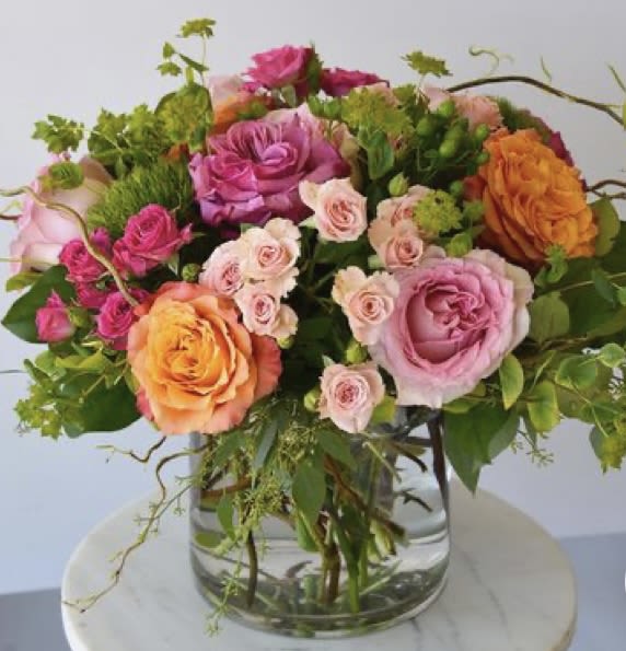 Garden melody  - Free spirit roses ,light pink roses , hot pink spray roses , light pink spray roses,bluplerum , curly willow in low cylinder vase 