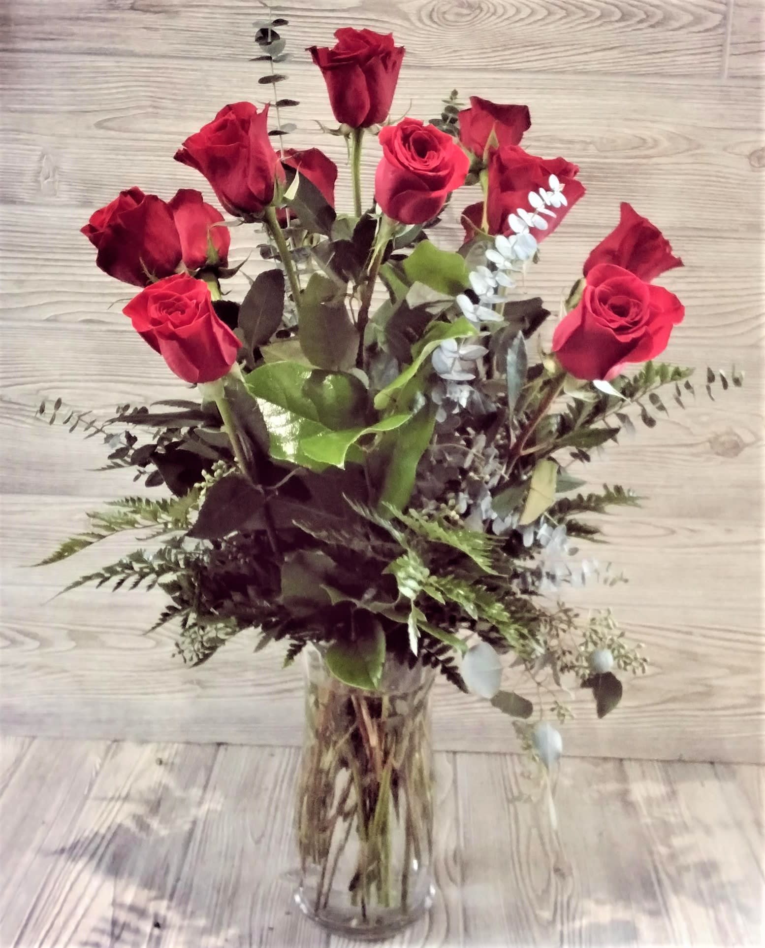 Love You - One Dozen (12) Long Stemmed Red Roses Arranged in a vase with greens. These dozen red roses are the classic romantic gift! Perfect for Valentine's Day or an Anniversary. There is no better way to say I Love You.  APPROXIMATE DIMENSIONS: 25&quot; H X 18&quot; W