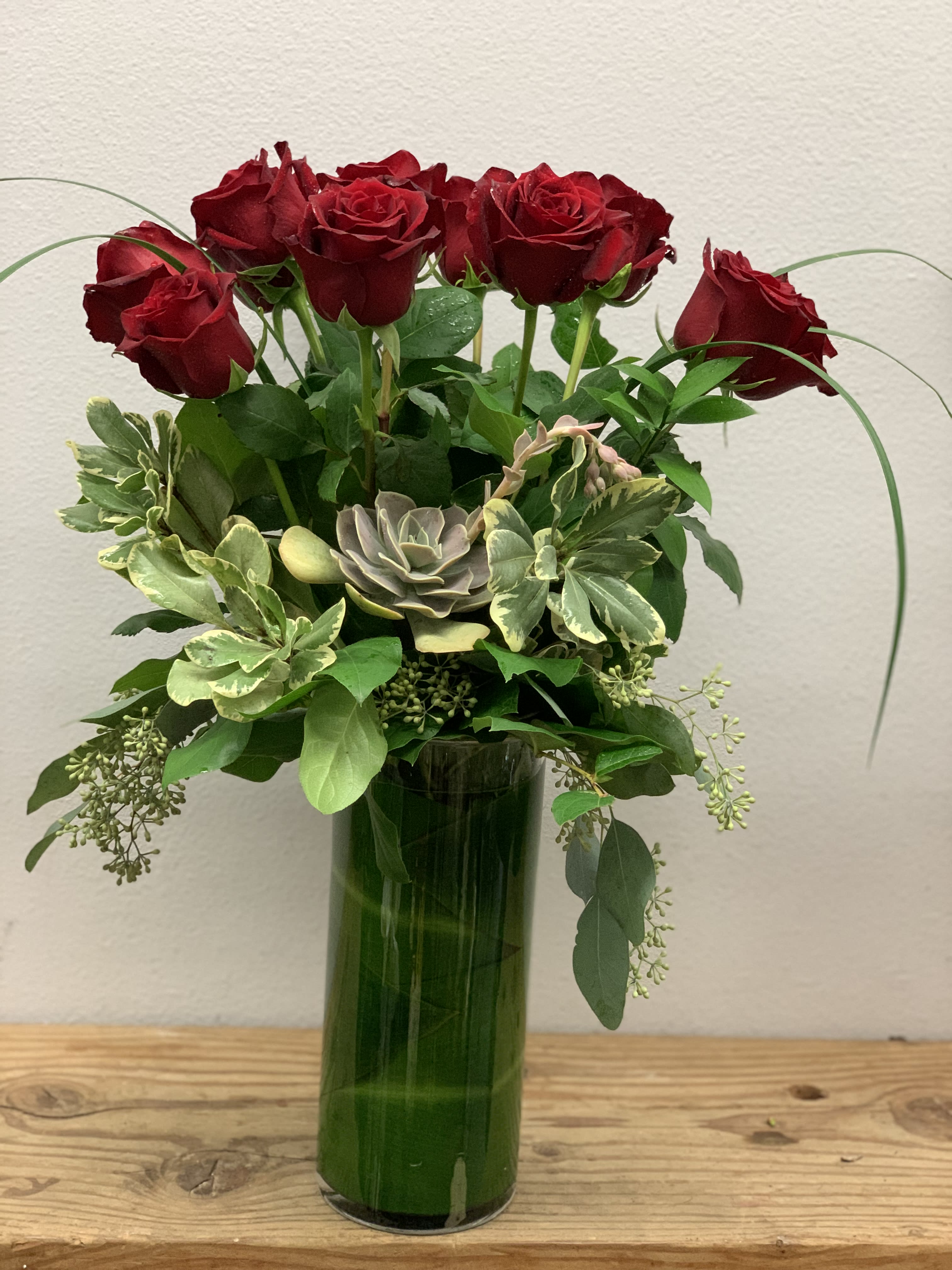 One Dozen Red Roses and Succulents - One dozen premium roses, succulents and a variety of greens.  Roses are available in red, white, pink, purple and yellow.  Please indicate first, second and third choice in special instructions.  