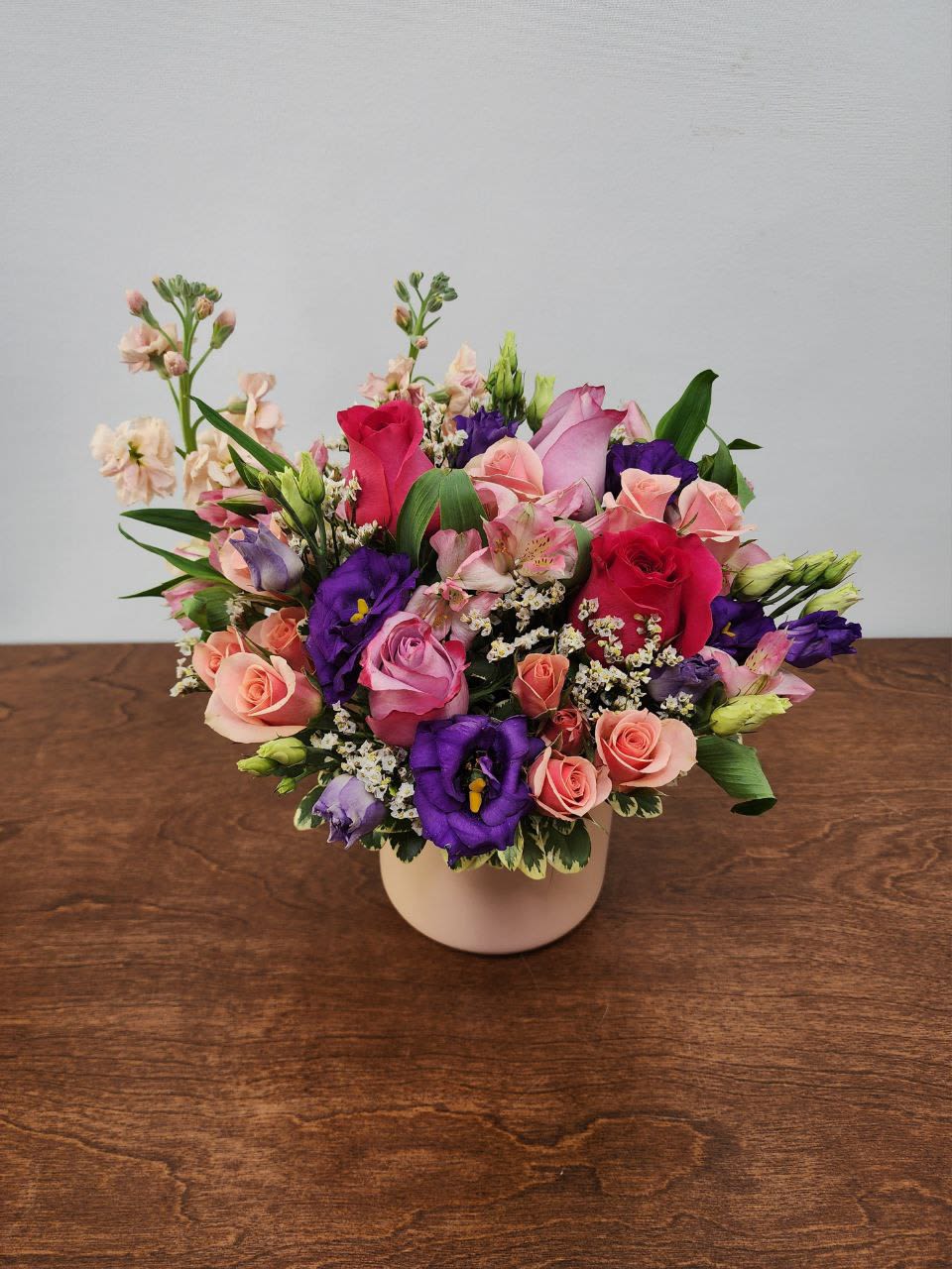 Romance Romance - Delicately designed soft and bright colors of roses accompanied by stock flowers and cushion mums in a beautiful and high quality colored glass vase, a perfect gift for Valentine's Day, Birthday and other occasions.