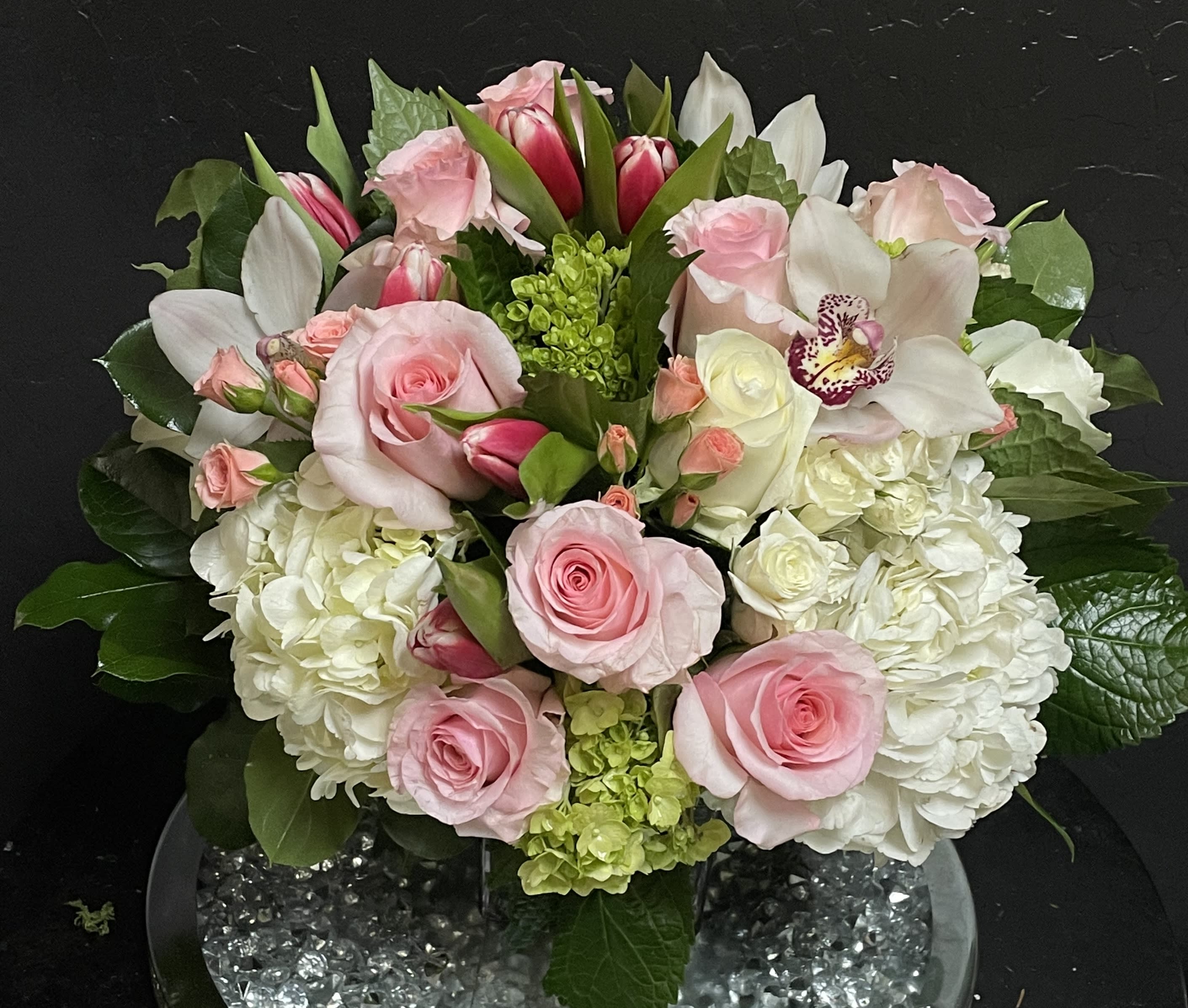 Elegant Bouquet Elegant Bouquet - This bouquet shows that there is beauty in simplicity. Elegant bouquet is the perfect gift for almost any occasion, especially for celebrations and showing gratitude. Arrangement Details: Includes white roses, blush pink roses, white cymbidium orchids, tulips, and white hydrangea. APPROXIMATE DIMENSIONS:10" H X 11" W X 11"L