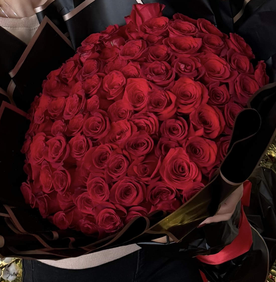 RADIANT LOVE - Radiant Love, a breathtaking bouquet of 100 premium red roses, elegantly wrapped; for a sophisticated and luxurious finish. This arrangement has a elegant variant features delicate LED lights, creating a magical and romantic glow—perfect for special occasions like anniversaries, proposals, or simply expressing eternal love. Let this symbol of passion and elegance light up any moment.  *AS SIMILAR AS POSSIBLE*  Substitution based on season, flowers availability or any unforeseen or uncontrollable circumstances  