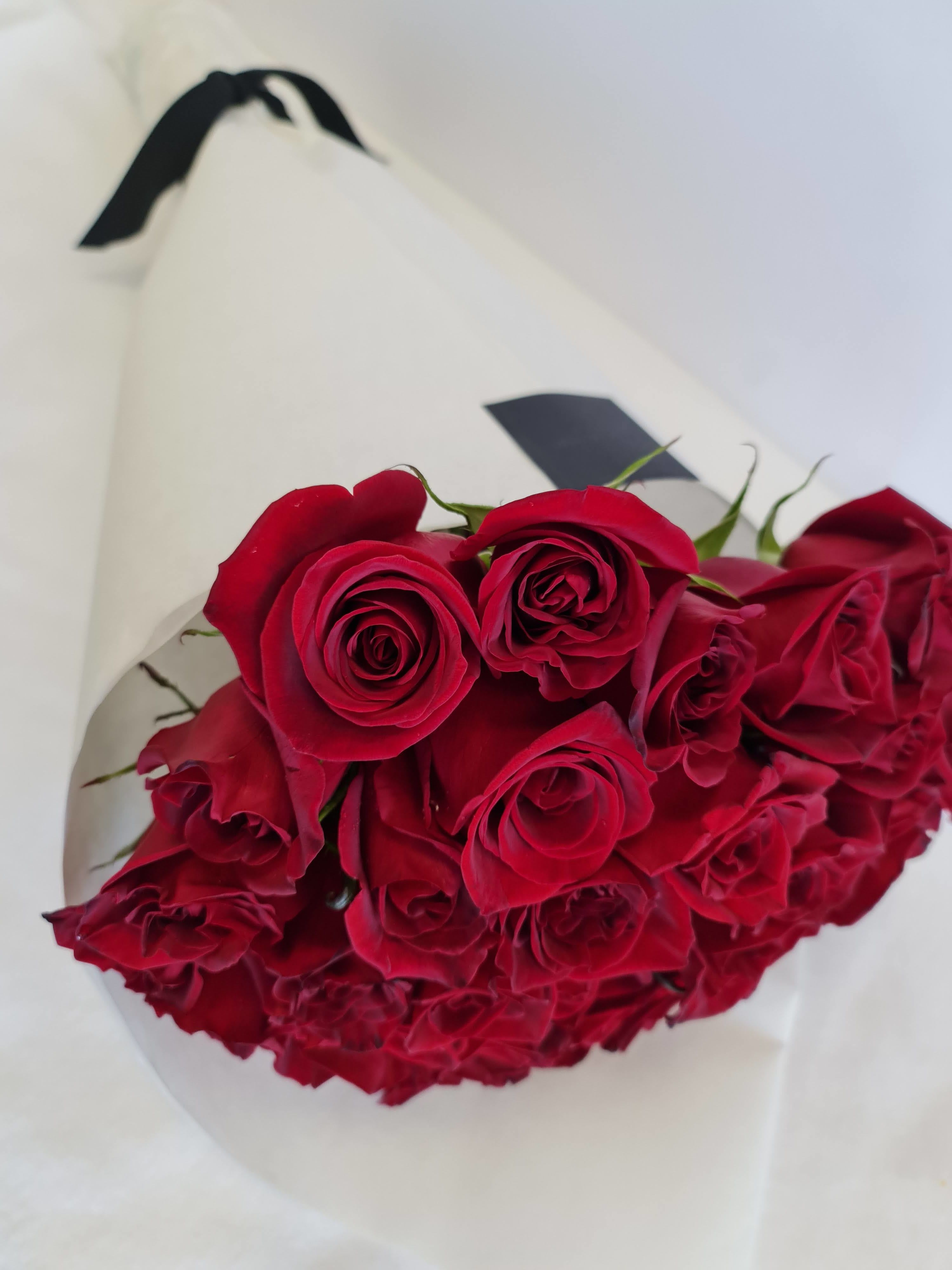 Passion - Make an unforgettable statement of love this Valentine’s Day with &quot;Everlasting Passion&quot;, a luxurious hand-tied bouquet of exquisite deep red roses. Wrapped in elegant white paper with a sophisticated black ribbon, this bouquet is the epitome of timeless romance and elegance.  Each premium long-stemmed rose has been carefully selected for its velvety petals, rich color, and lasting freshness, ensuring that your special someone receives the finest floral expression of love. Perfect for those who appreciate classic beauty with a modern touch, this bouquet embodies passion, devotion, and elegance.  Whether you're celebrating an anniversary, a romantic milestone, or simply expressing deep affection, &quot;Everlasting Passion&quot; is the perfect gift to leave a lasting impression.   Ideal for: Valentine's Day, Romantic Gestures, Anniversaries, Luxury Gifts  Dimensions: Approx. 24&quot; high x 12&quot; wide  #Luxury Valentine's Roses,  #Premium Red Rose Bouquet,  #Elegant Floral Gift,  #Timeless Romantic Flowers,  #Long-Stemmed Roses,  #Hand-Tied Bouquets