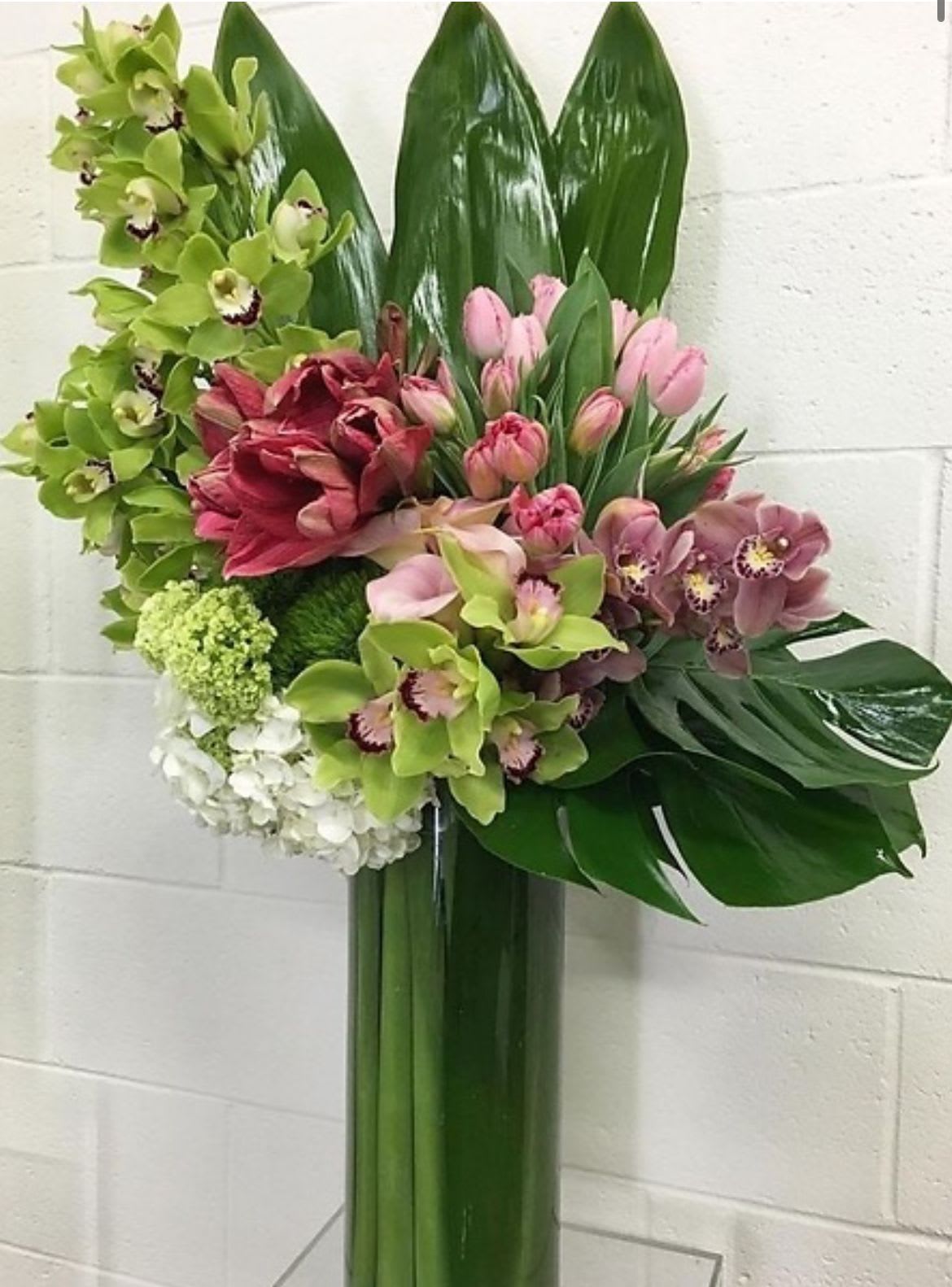 Pink tulips in earth - An amazing set of tulips, orchids, roses and hydrangeas in a large glass container 