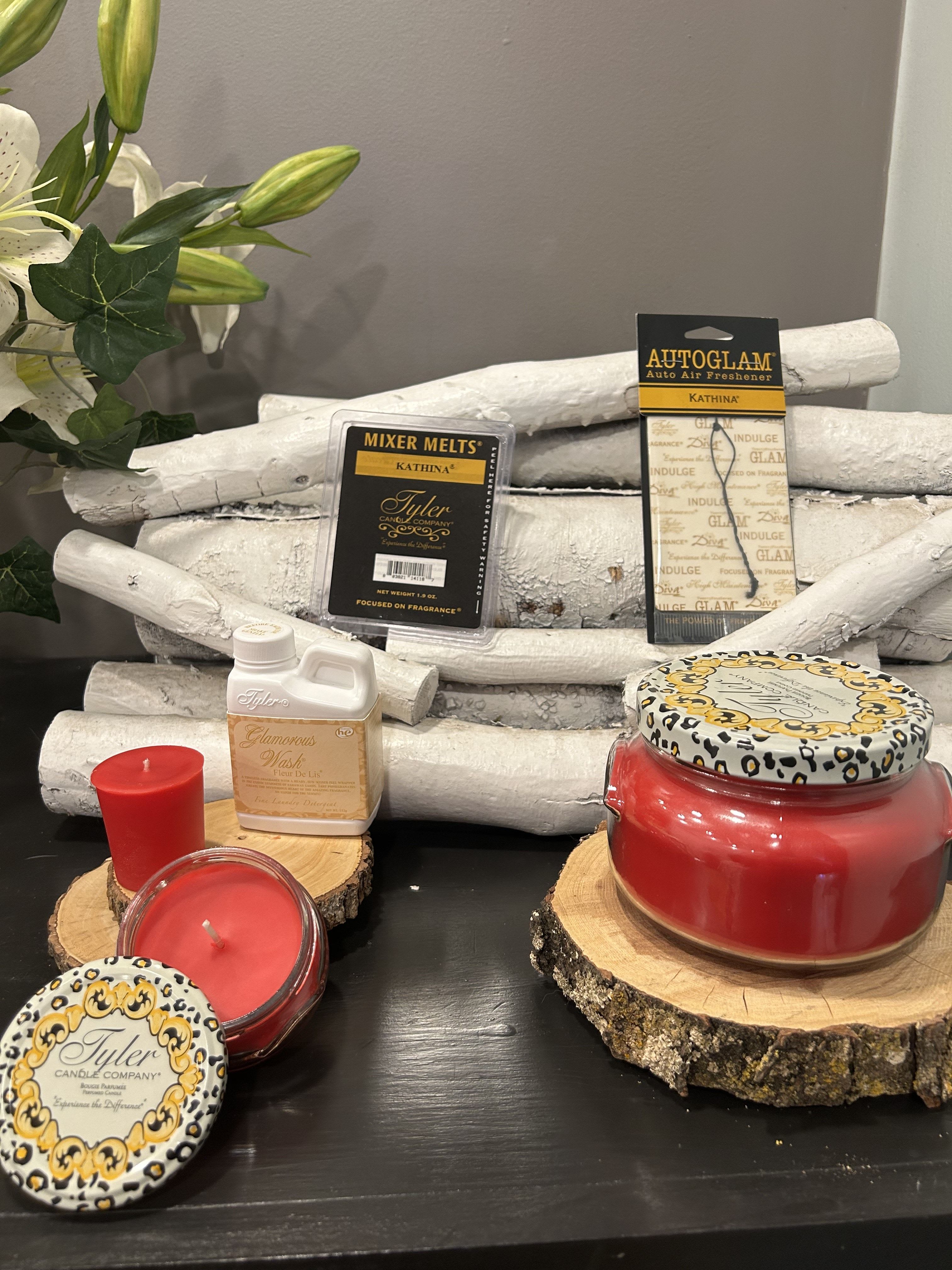 Kathina Candle Gift Set - The Sensual Lily of the Valley mixed with citrus and rose sounds like a bold and intense fragrance, definitely making a statement with its richness and complexity.  Here’s the breakdown of the new set you mentioned:  Large 22oz Candle: A large candle to fill your space with that dramatic, floral, and citrusy scent. Small 3.4oz Candle: A smaller version of the larger candle, great for travel or smaller areas. 15-hour Votive: A long-lasting, smaller candle that still packs that intense fragrance. 112g Luxury Laundry Detergent: Adds a luxurious, dramatic floral scent to your clothes after washing. Autoglam Car Freshener: Keeps your car smelling dramatic and fresh, like the intense floral-citrus blend. Wax Melts: A way to spread the luxurious fragrance around your home without an open flame, for a longer-lasting scent experience. It sounds like this set is ideal for someone who loves strong, captivating floral and citrus scents. With the combination of Lily of the Valley, citrus, and rose, it's definitely a scent that makes an impact!