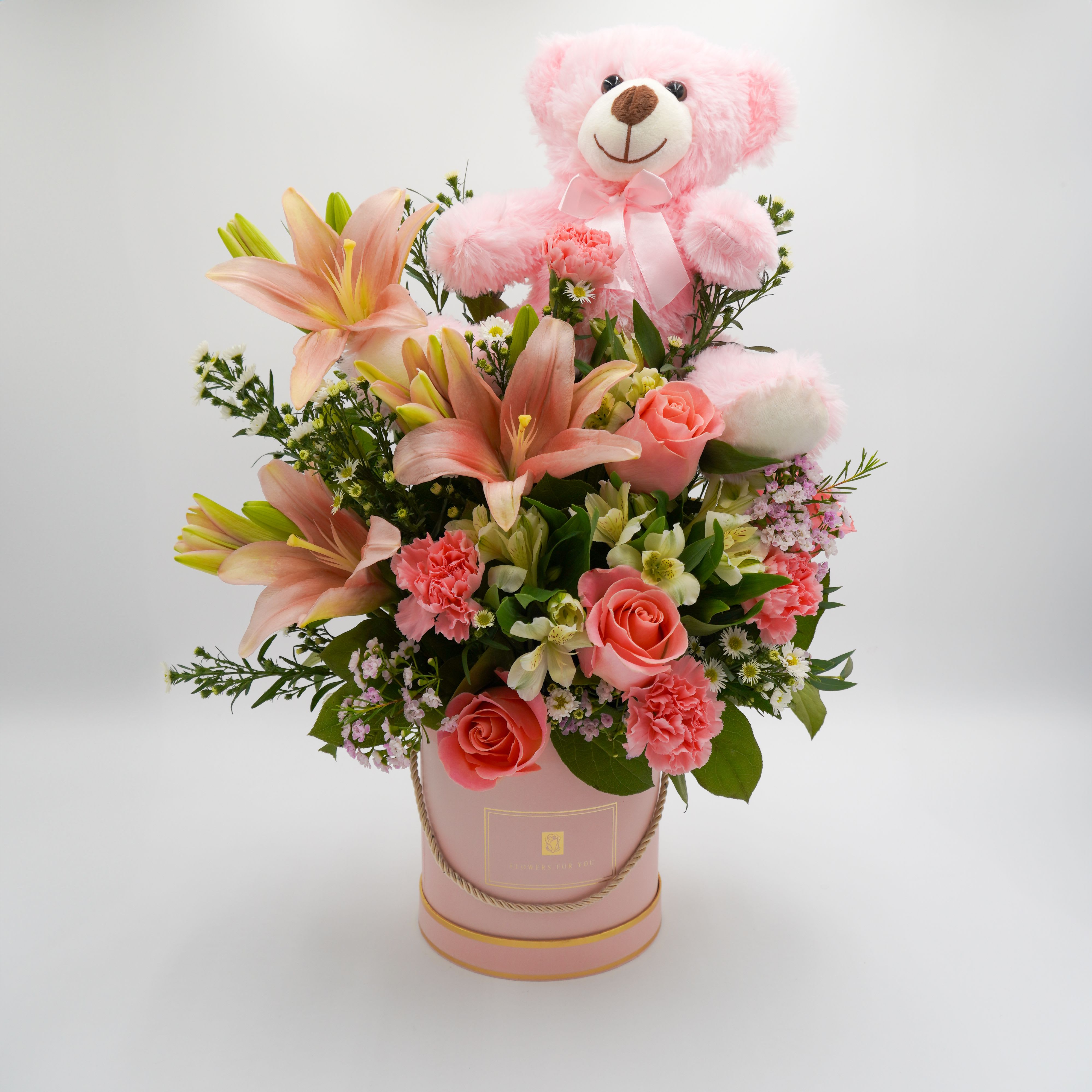 It's A GIRL! by Atlanta's Finest Flowers - Includes Lillies, roses, carnations, Alstroemeria, white aster, wax pink, mixed greenery and Pink Teddy Bear on top *box material*: Size 7x7 