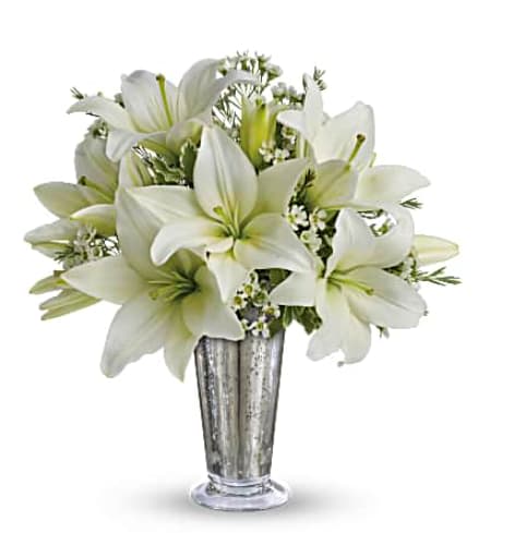 Written in the Stars by Teleflora - Echoing a romantic night sky, this classic arrangement of silver and white is perfect for a silver anniversary or any special star in your life. Fragrant snow-white lilies and a stunning mercury glass-style keepsake vase invite your lucky someone to wish upon a star! Striking white asiatic lilies and delicate white waxflowers. Hand-arranged in an eye-catching Mercury Glass Antique vase, exclusively from Teleflora. Orientation: All-Around