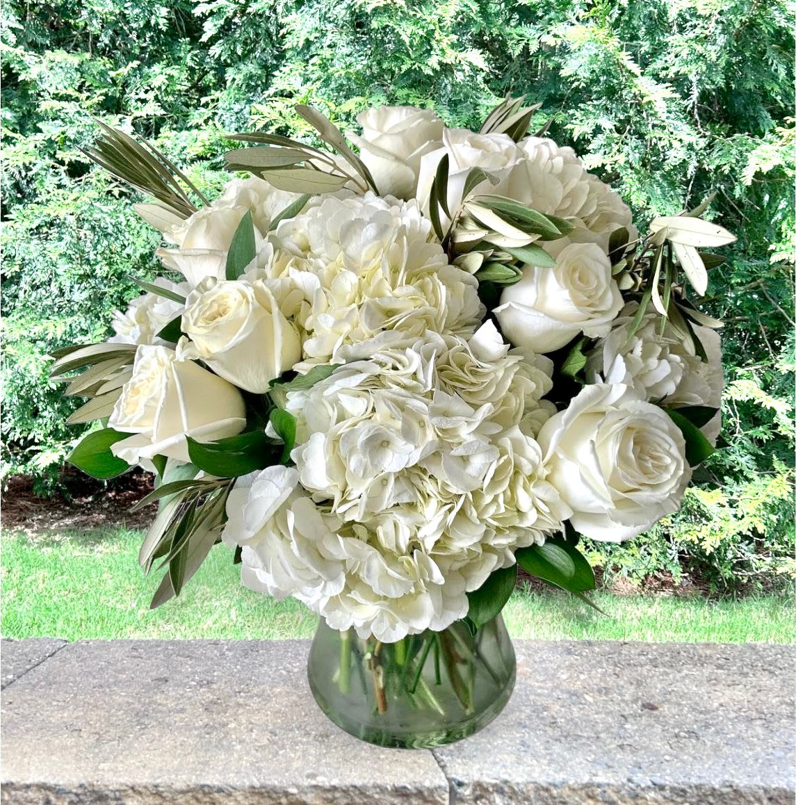 Luz Bouquet Luz Bouquet - Clean and simple elegance Luz Bouquet Bloom Details: White Roses, White Hydrangeas, and Israeli Ruscus Clear Glass All Occasion Place your Order Online Monday to Saturday before 1:00 p.m. (E.T.) for same-day delivery. “Orders received after hours will be delivered the next business day”. Check our coverage area. Occasionally, flowers and/or container substitutions happen due to weather, seasonality, and market conditions, which may affect availability. If this is the case with the gift you’ve selected, we will ensure that your arrangement's style, theme, and color scheme are preserved and will only substitute items of equal value or higher value. CARE INSTRUCTIONS Keep the flower arrangement hydrated with natural water and change the water every two days. Do not spray any cleaning product on the flower arrangement. Do not place heavy objects directly on the flower arrangement. Keep flower arrangements out of direct sunlight and extreme heat.