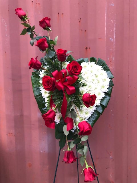 Bleeding Heart Standing Spray - The bleeding hearts is timeless classic option that vividly displays how you feel. Our standing spray arrangement - in the shape of a heart - is created from fresh white mums and red roses and is accented with greenery. 