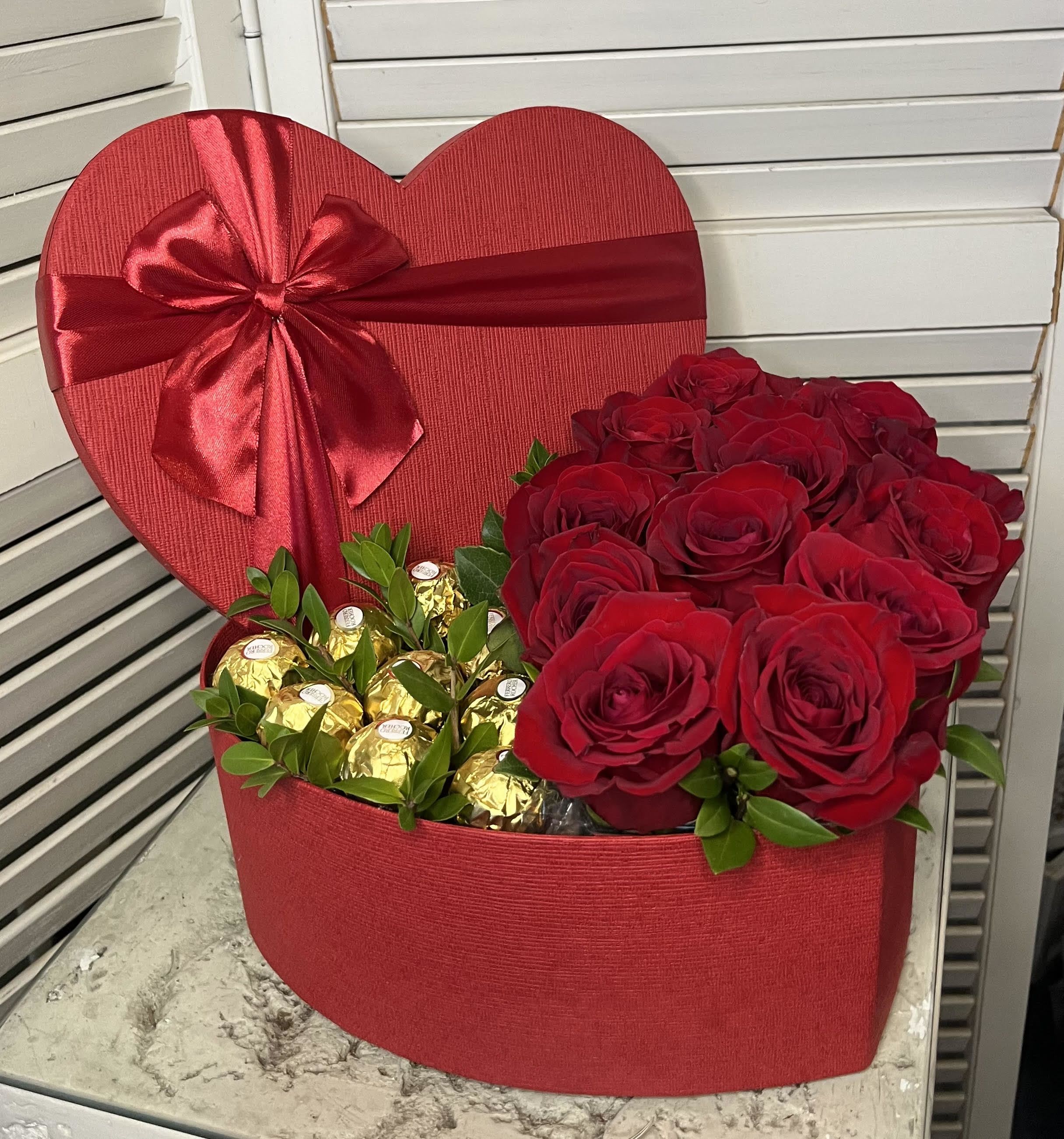 Roses and Chocolate - Dozen Roses and 9 Chocolate arrange in a heart shape box perfect for your Valentine or just to say I Love You!  (Roses available in different colors)