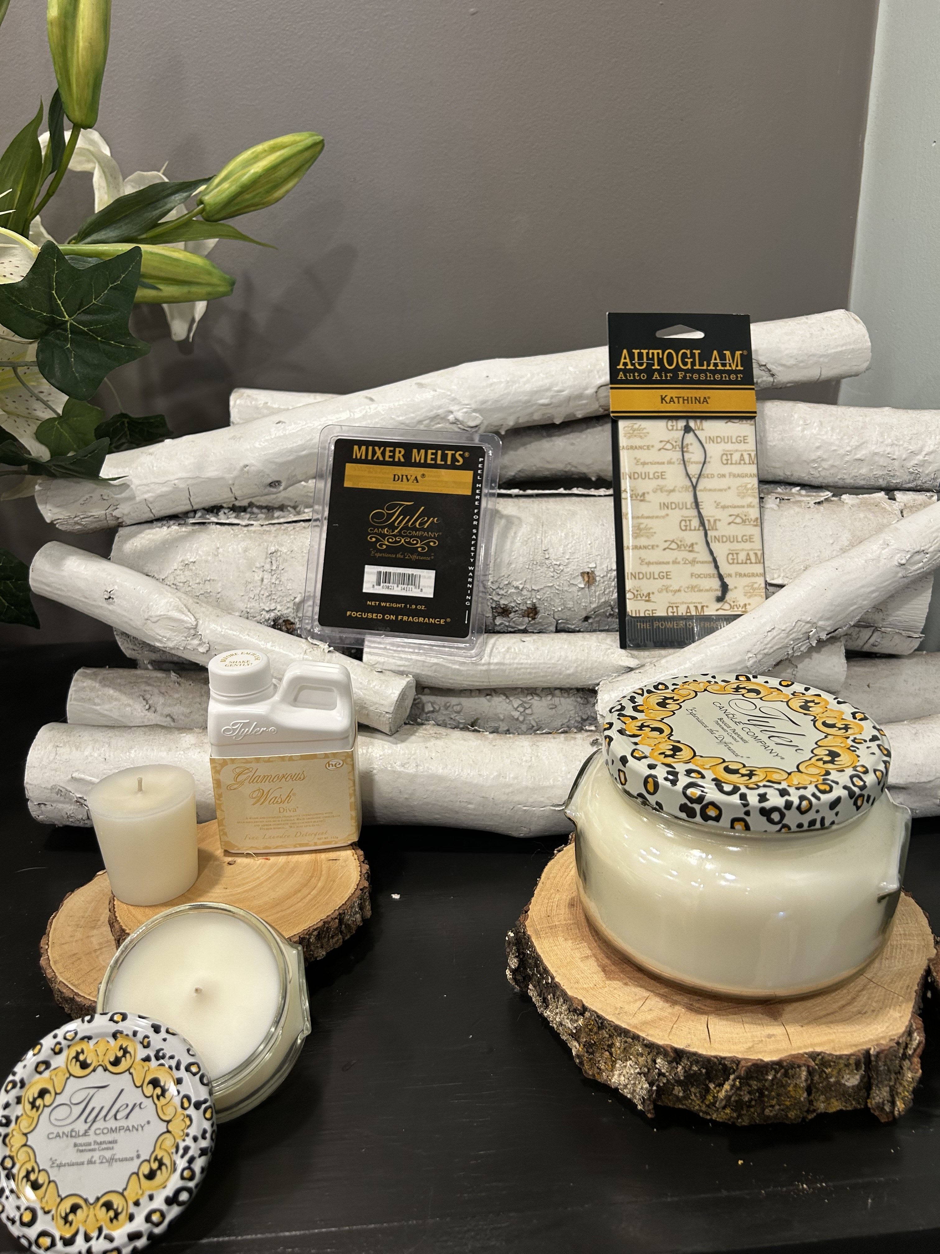 Diva Candle Gift Set  -  Diva is a warm, complex, and luxurious! With the delicious fruits and rich florals as the star players, along with aromatic chocolate and amber, this blend evokes a sense of decadence and sophistication. It’s a perfect fit for those who love to embrace their inner diva and celebrate their bold, confident spirit!  The set includes:  Large 22 oz Candle – The large candle creates an opulent atmosphere, filling your space with a lush, warm fragrance of fruits, florals, chocolate, and amber, perfect for creating a diva-worthy ambiance. Small 3.4 oz Candle – A more portable version for smaller rooms or to enjoy this luxurious scent on the go. 15 hr Votive (112g) – This votive lets you bask in the decadent scent for a shorter period, creating an intense and indulgent experience. Luxury Laundry Detergent – This would be a great way to infuse your clothes with that fabulous, fruity-chocolate-floral scent, making every outfit feel glamorous. Autoglam Car Air Freshener – Now, your car can be as stylish as the diva you are, with this rich, complex fragrance accompanying every drive. Wax Melts – Enjoy this intoxicating scent throughout your home or workspace without the need for an open flame, creating a continual flow of luxury. This set seems like the perfect gift for someone who loves to live life with confidence and a bit of luxury, or even for treating yourself to a glamorous experience. It’s definitely designed for anyone who loves indulging in sweet, rich, and floral fragrances. 