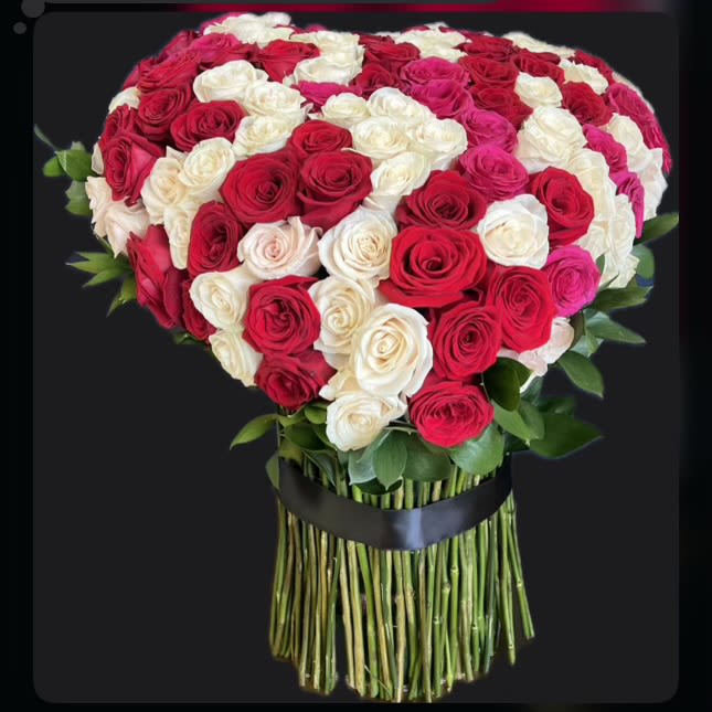 Trinity of Romance Trinity of Romance - Trinity of Romance: A Captivating Blend of Roses Celebrate the beauty of love with Trinity of Romance, a magnificent bouquet of 150 premium roses, artfully arranged in a harmonious blend of red, white, and pink. Each color represents a unique sentiment: red for passion, white for purity, and pink for admiration, coming together to symbolize a complete and timeless expression of affection. The bouquet’s vibrant hues and lush greenery create a perfect balance of elegance and charm, making it an ideal gift for anniversaries, weddings, or any momentous occasion. Hand-tied and finished with a luxurious black ribbon, Trinity of Romance is designed to leave a lasting impression. Features: • 150 handpicked, long-stem roses in red, white, and pink. • Enhanced with fresh greenery for a polished look. • Luxurious hand-tied design with a satin ribbon finish. • Perfect for romantic gestures or grand celebrations. Express your love with the captivating beauty of Trinity of Romance—a bouquet that speaks from the heart.
