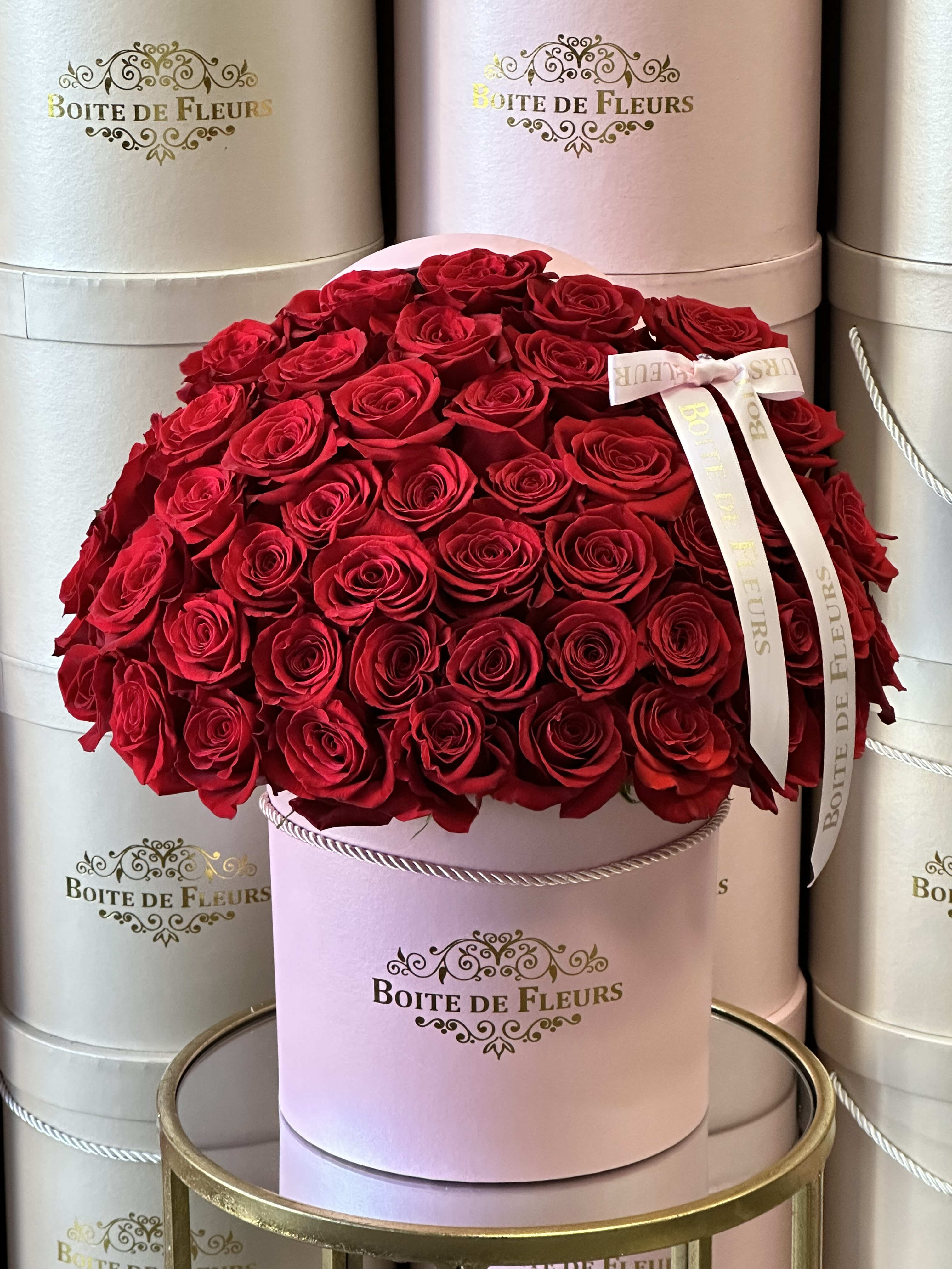 Roses n Bows - Red premium roses in a pink box.  65 roses