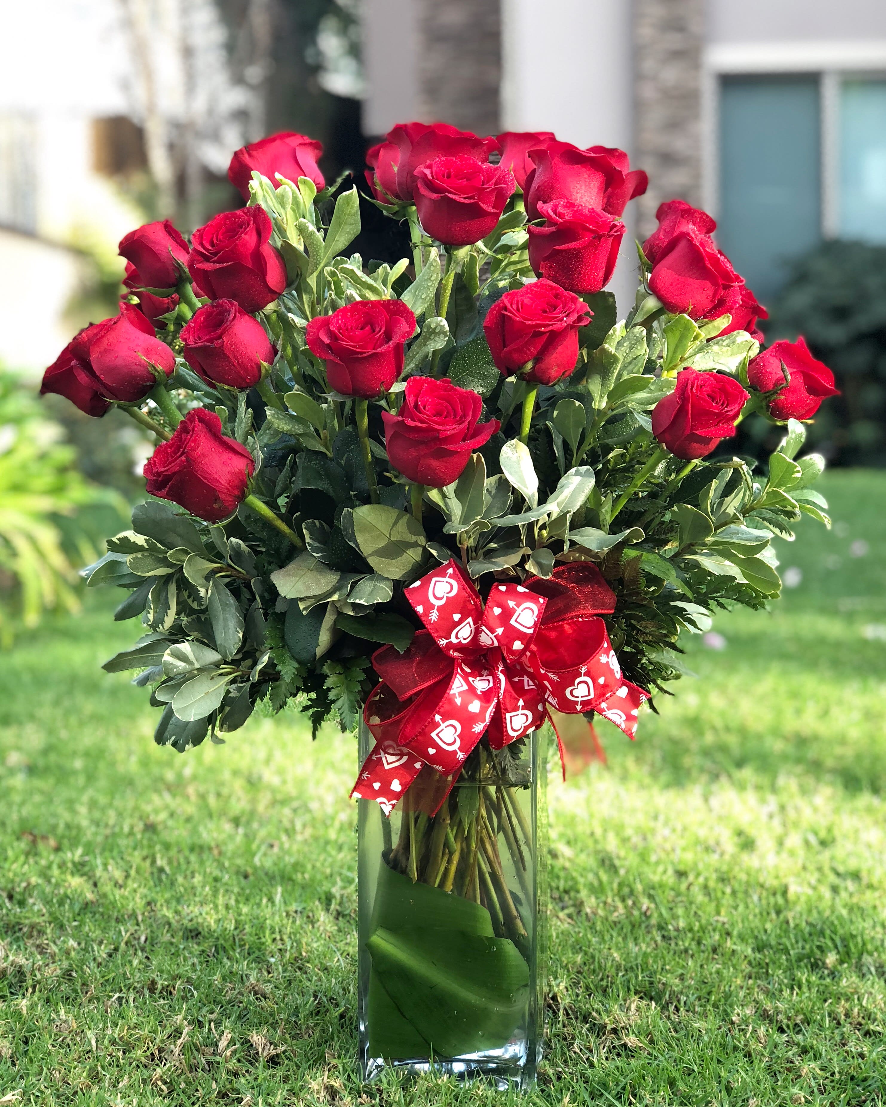24 Roses With Love - 24 roses with 24 reasons to love on Valentine's Day! Order this beautiful 24 extra long stem Ecuadorian red roses elegantly arranged with fine greenery and bow! Hand made and delivered to your loved ones doorstep with a smile...   Order today to guarantee delivery on Valentine's Day!!!  Approximately 23&quot; H x 15&quot; W