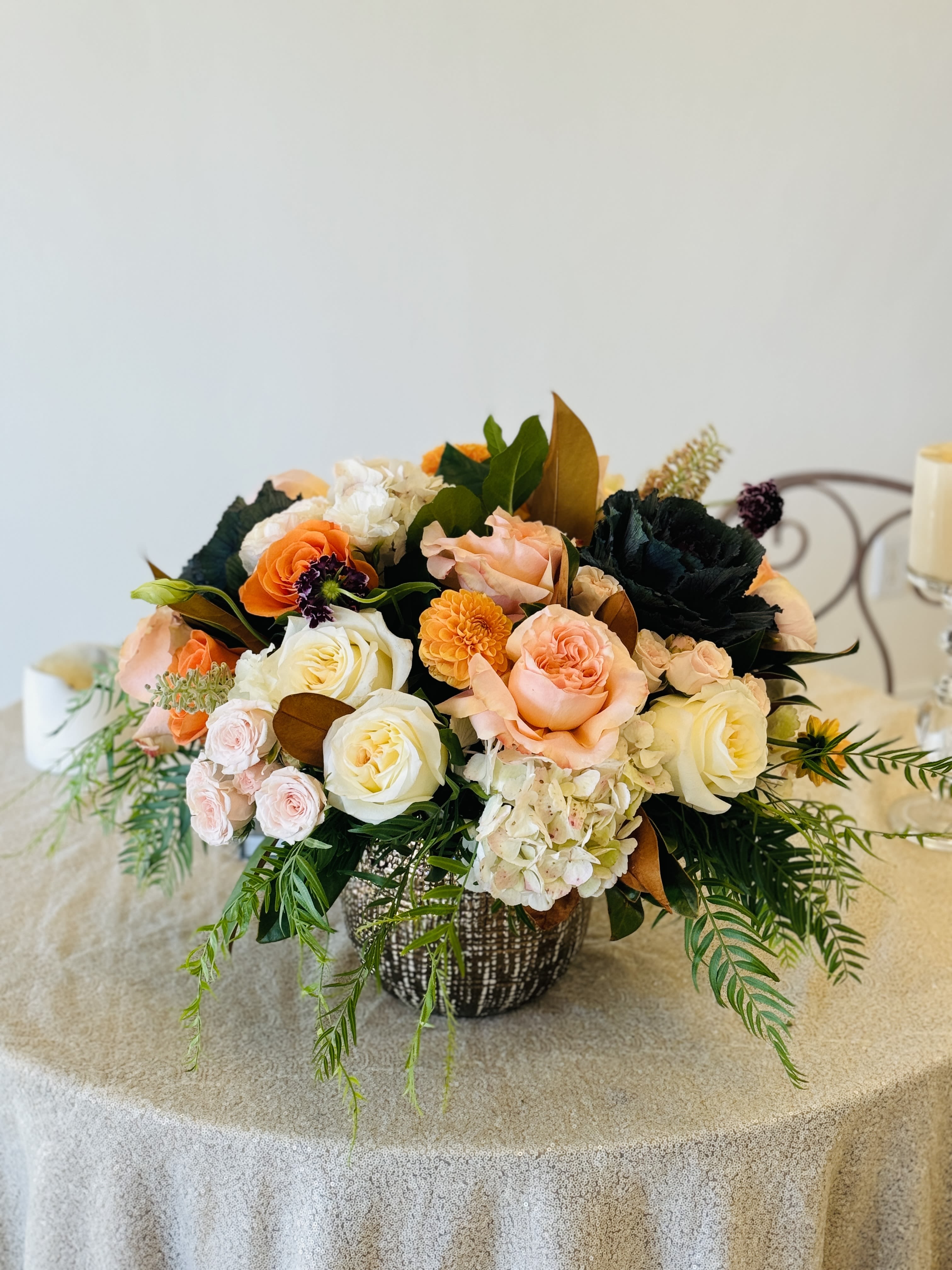 Orange Delight Orange Delight - This beautiful arrangement is in a 7 x 7 vase with different shades of Dahlia’s and garden flowers.