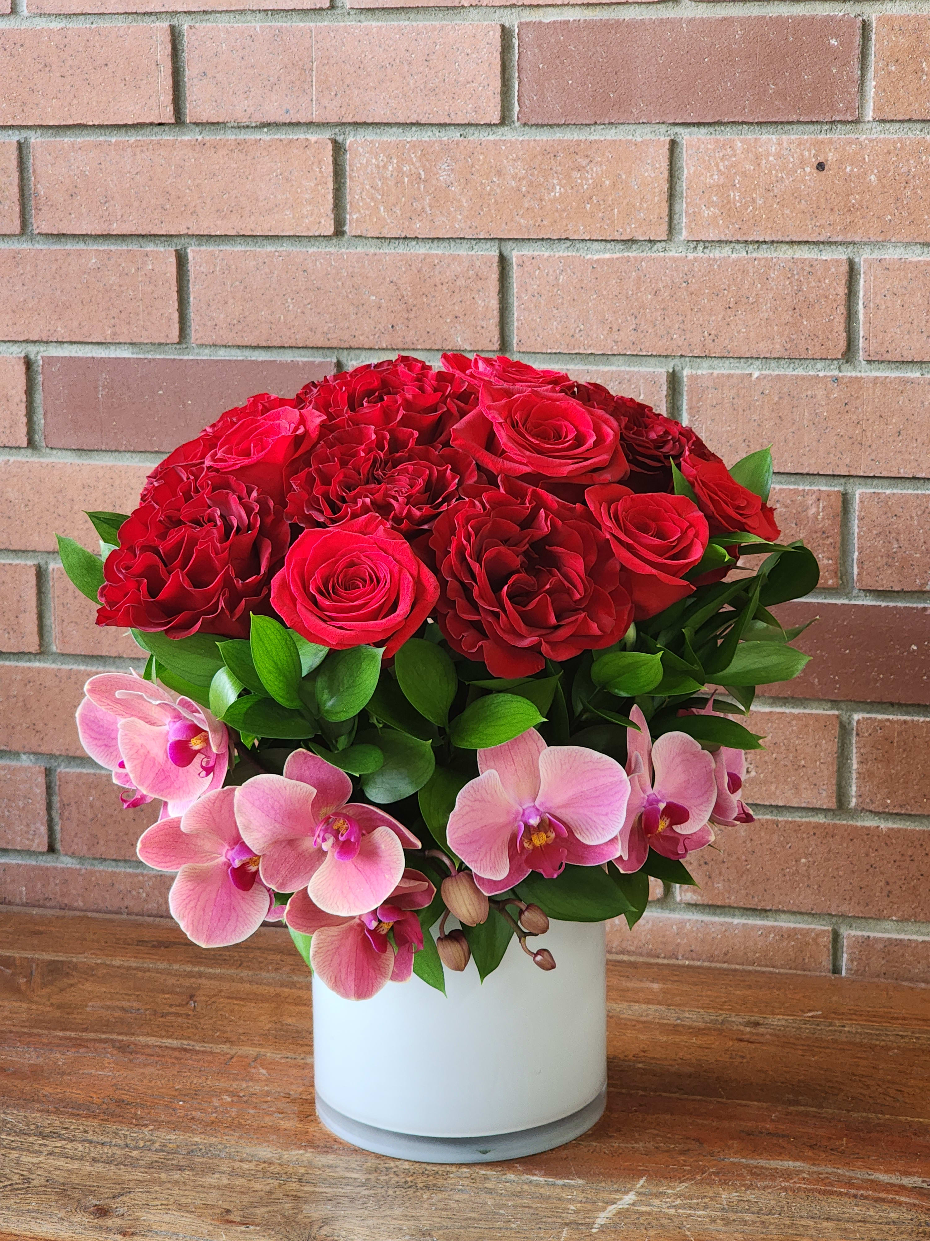 Premier Bouquet  - Send our lovely red rose and orchid bouquet to the premier person in your life.  Standard as pictured. Deluxe and premium will get extra blooms worth the upgraded amount.  