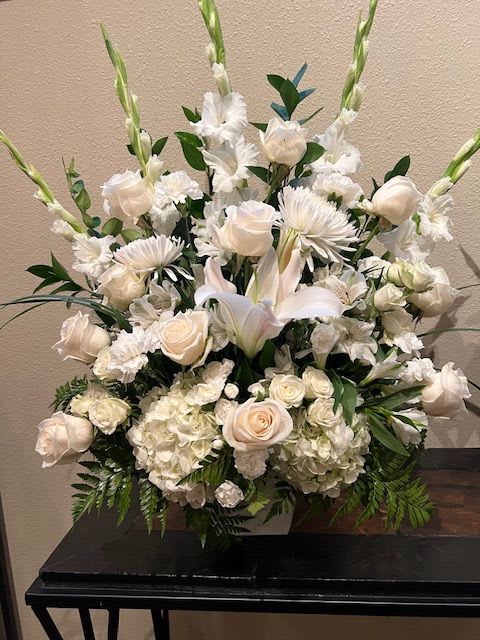 Elegant White - This all white arrangement takes center stage. Tall and elegant with white roses, gladiolas, hydrangeas, lilies, spray roses and carnations and mixed greens. Size 20&quot; wide and 24&quot; tall. In low container.