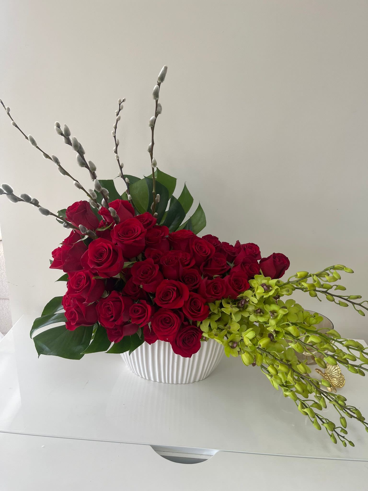 Red Zone - Designer arrangement roses and orchids in a designer box that enhances their beauty. 