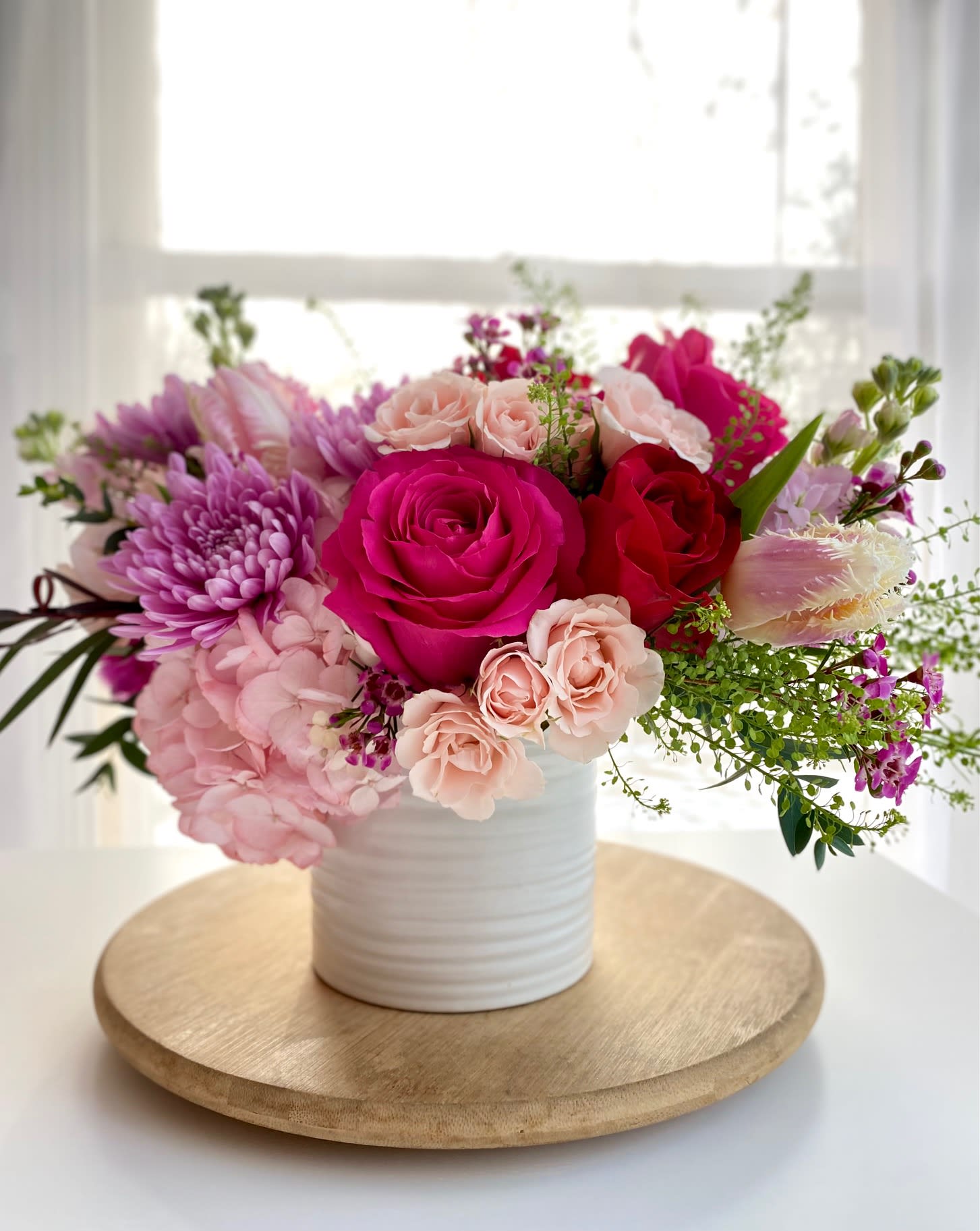 Water your Soul with LOVE - This arrangement reminds us of these words:  &quot;the way she's such a soft thing,  and still lets everything made of fire run so wild in her veins&quot;                         - butterflies rising A mix of gentle pink toned flowers arranged in a ceramic vase. Like a warm and gentle hug...  This medium size arrangement will include (based on availability) spray and pink roses, stock, cremon (mum), hydrangea, tulips and greenery. 
