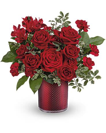 Radiant Crimson Bouquet - As radiant as your love, this romantic red rose bouquet looks ravishing inside a pearlescent scarlet vase with embossed diamond pattern. This rich bouquet features red roses, red spray roses, red alstroemeria, miniature red carnations, lemon leaf and pitta negra. Teleflora's Radiant Crimson Bouquet is delivered in Teleflora's Scarlet Diamond Cylinder. Orientation: All-Around