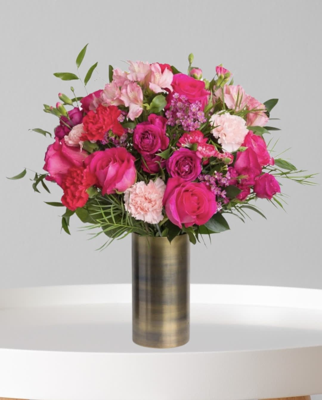 Passion Pink Floral Passion Pink Floral - This Beautiful Arrangement Of Assorted Pink Flowers Include Roses, Spray Roses, Alstroemeria, Mini carnations and Carnations. A Perfect Blend Of Passion Designed In A cylinder Vase (Vase May Vary In Colors Available)