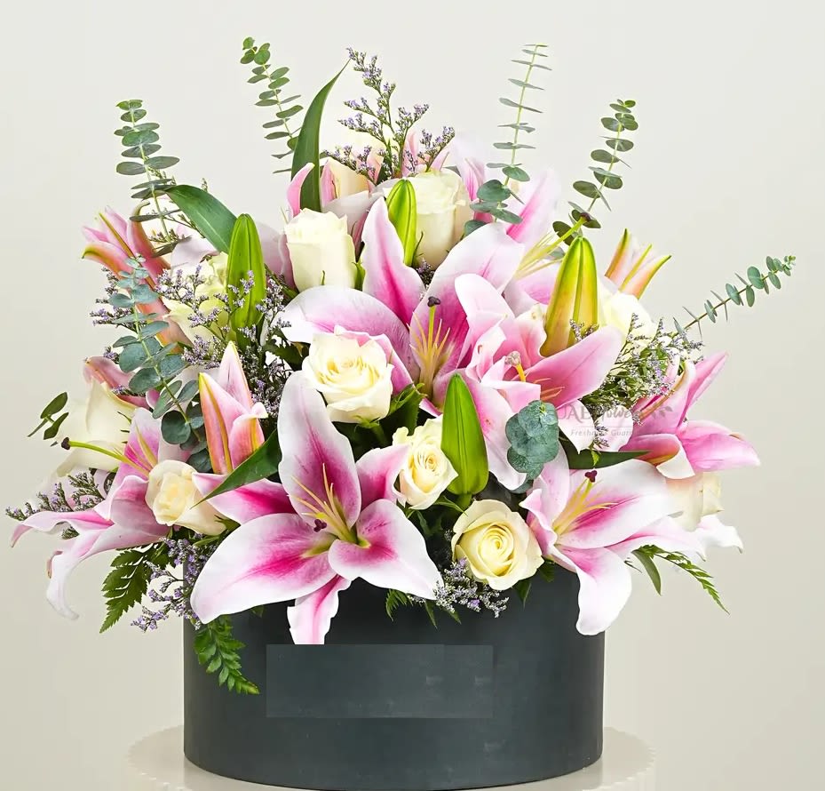 expressing love, Arrangement expressing love, Arrangement - Gracefully arranged in a chic black box, this stunning floral arrangement features vibrant pink lilies and elegant white roses, accented with fresh eucalyptus leaves and delicate limonium fillers. This luxurious display is perfect for bringing beauty and sophistication to any occasion.