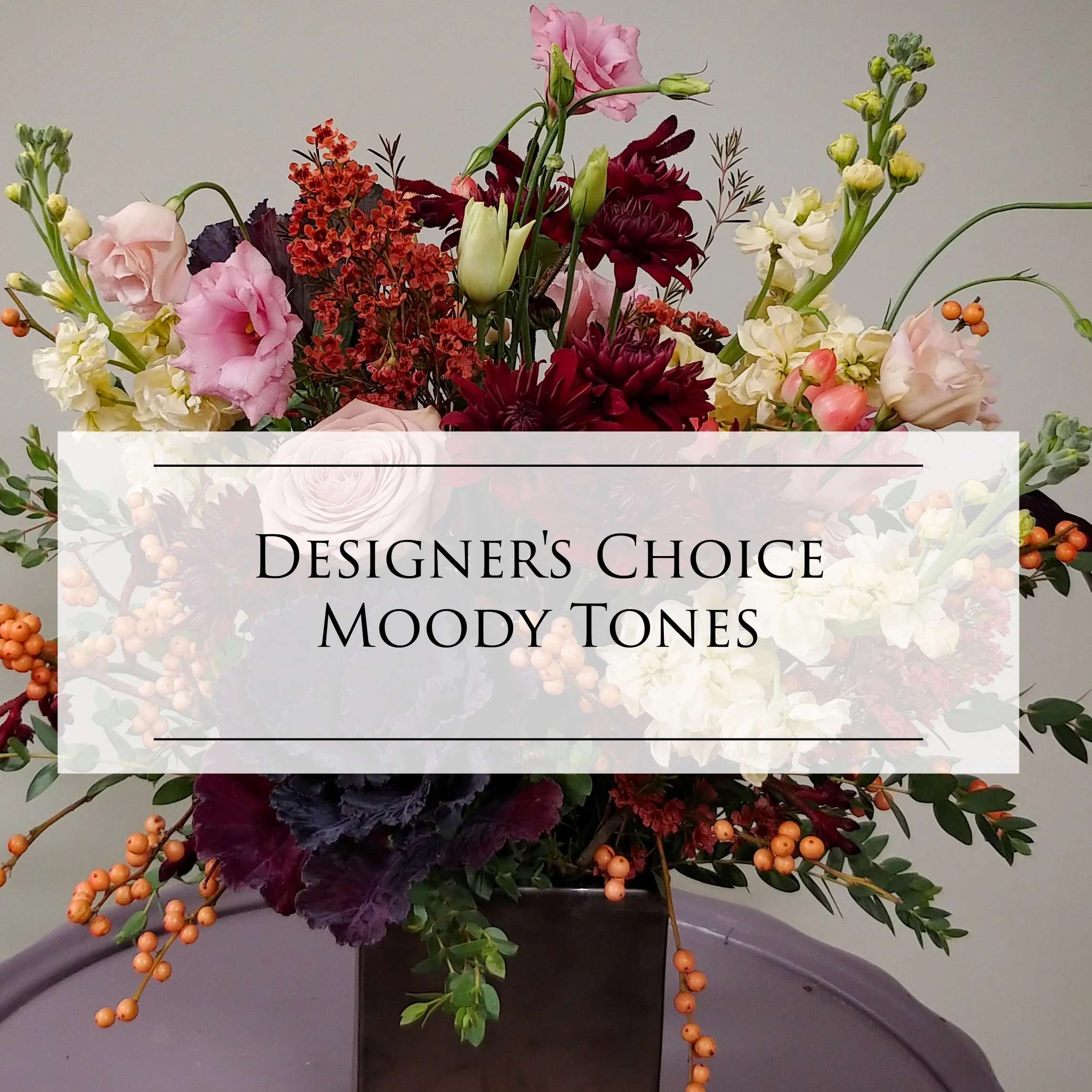 DC- Designer's Choice - Moody DC- Designer's Choice - Moody - This selection really focuses on darker tones but lightens them up a bit with hints of a softer palette peaking through. Please Specify if you would like a wrapper bouquet or a vase Arrangement at check-out. Please Note: Each design is custom made and filled to value. We only use fresh product to ensure top quality so new orders are subject to substitutions.