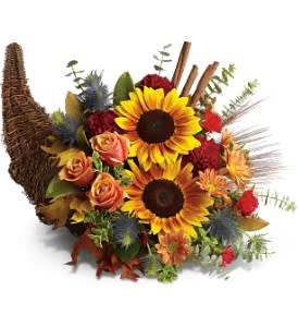  Bountiful Beauty  - What could be more festive than a &quot;horn of plenty&quot; overflowing with autumn's cheeriest flowers. Doesn't it make you happy just to look at it? Order this radiant centerpiece for your holiday table.  The bright autumn arrangement includes sunflowers, bronze daisy spray chrysanthemums, eryngium, burgundy carnations, red miniature carnations and orange roses accented with fresh greenery, preserved leaves and dried wheat.  Delivered in a 14&quot; wicker cornucopia.  Bouquet is approximately 18&quot; W X 13&quot; H  Orientation: One-Sided      As Shown : TFWEB587  