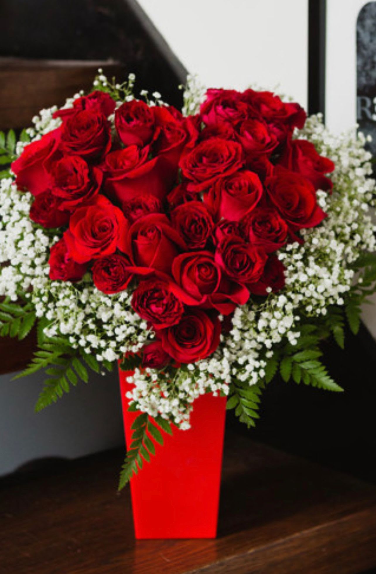 Passion Heart - Send someone this soulful floral gift, and there'll be no mistaking that you're giving them your heart! A heart made entirely of red roses is nestled in a cloud of white baby breaths 