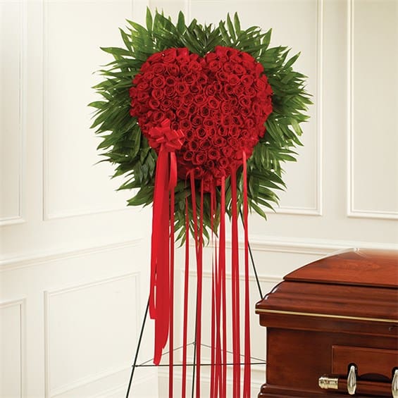 Standing Red Rose Bleeding Heart - When words arent enough to express the depths of your love, this heart-shaped arrangement makes an unforgettable statement and a stunning tribute. Crafted from 150 fresh red roses in a solid heart Traditionally sent by immediate family and delivered irectly to the funeral home Measures approximately 36&quot;H x 38&quot;W without the stand Only the freshest flowers are used, so colors and varieties may vary 