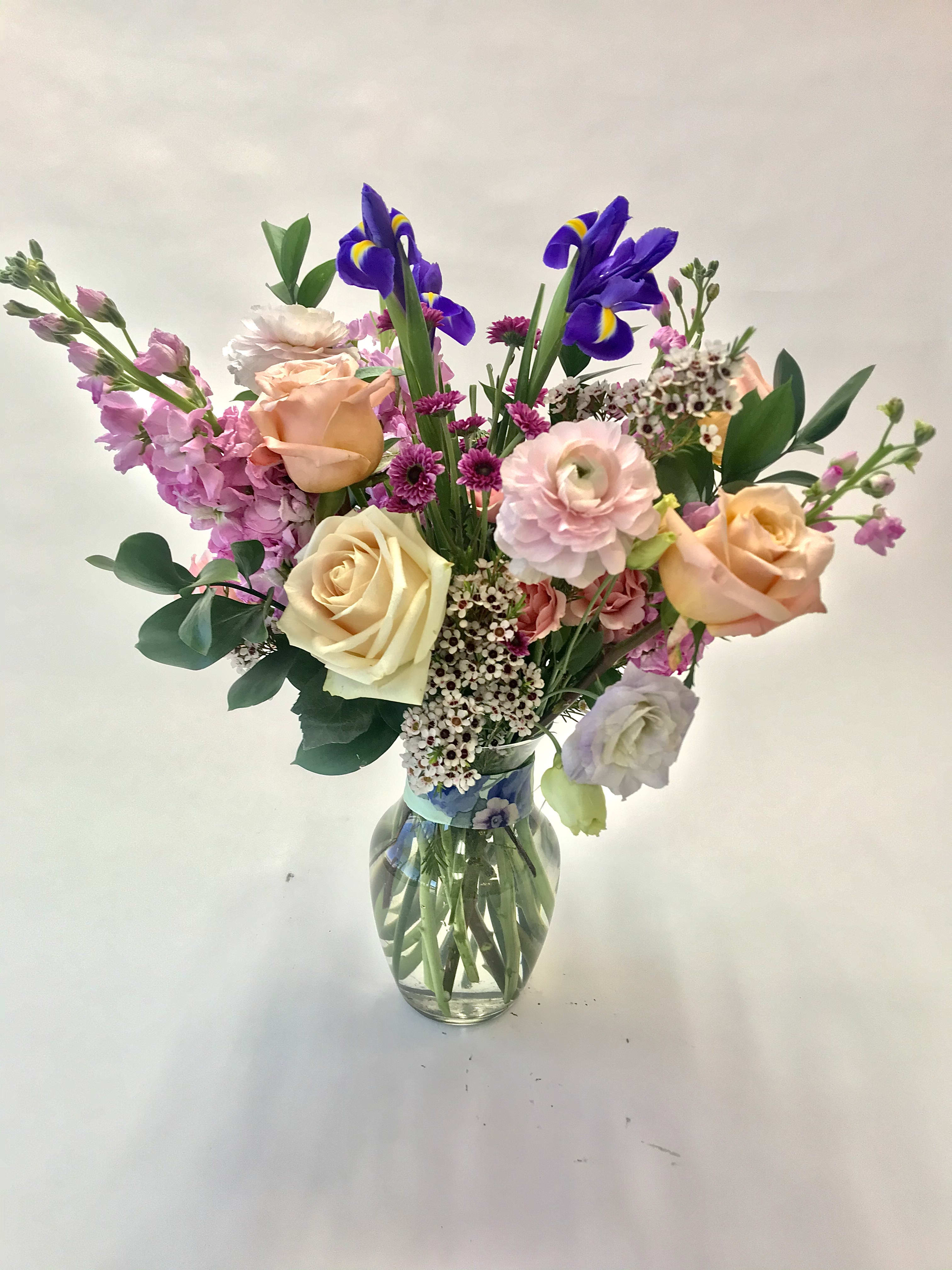 The McKean - A custom designed arrangement by Fairbanks Florist. A beautiful collection of mixed seasonal flowers that are fresh in our shop the day of delivery. We try our best to design something similar to what is pictured, but our shop does custom design - so each arrangement is a little different, but has the same spirit, beauty and freshness.  Your arrangement will be designed in the style shown but flowers and containers may be different from that pictured. Our designers make every effort to use the best floral selection of the day.