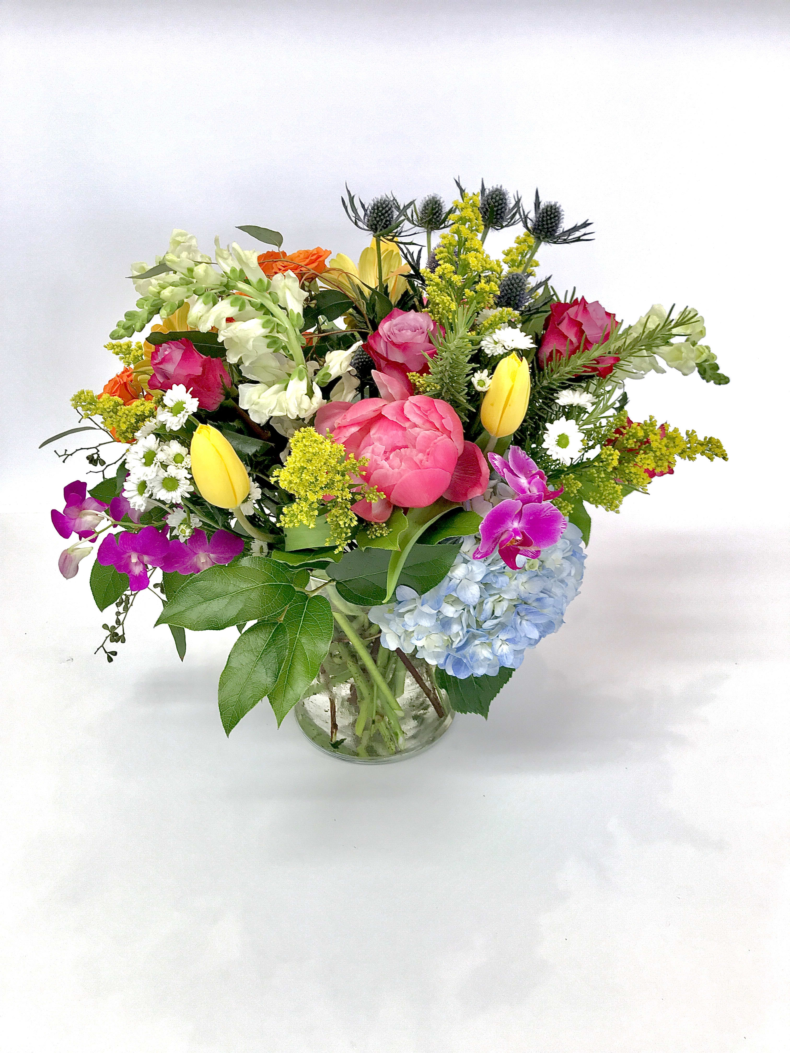 The Orlando - A custom designed arrangement by Fairbanks Florist. Designers choice made up of a collection of mixed seasonal flowers that are fresh in our shop the day of delivery. We try our best to design something similar to what is pictured, but our shop does custom design - so each arrangement is a little different, but has the same spirit, beauty and freshness.  Your arrangement will be designed in the style shown but flowers and containers may be different from that pictured. Our designers make every effort to use the best floral selection of the day.