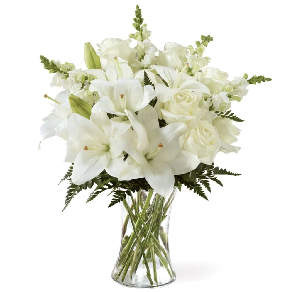 Eternal Friendship Bouquet Eternal Friendship Bouquet - A bouquet of bright, white blooms is a timeless way to deliver expressions of comfort. Our Eternal Friendship Bouquet sends your condolences with an array of roses, snapdragons and lilies. While this bouquet is perfect in size, it is best fit for a small table, or for sharing your sympathies to a home or residence. Includes: • White Roses • White Lilies • White Snapdragons • Leatherleaf Fern • Clear Glass Vase • Personalized Card Message