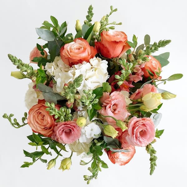 Eleanor - The Eleanor is a Bright summery bouquet with Hydrangea, Roses, Snapdragon and Lisi. Wrapped and Hand-Tied with Burlap. 
