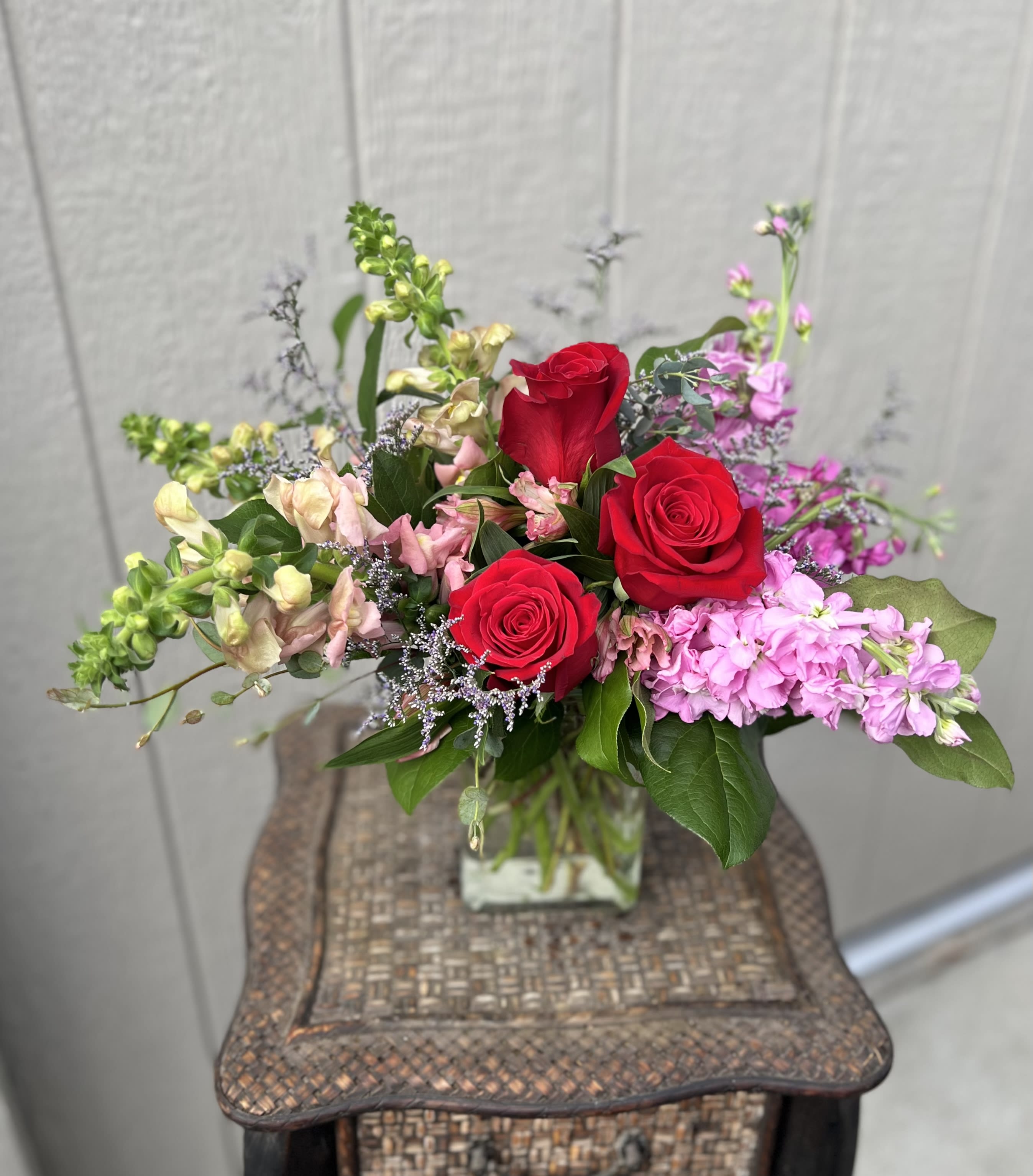 Love You So - Romantic colors for such a sweet day, includes roses, snap dragon and stock. Colors may vary. 