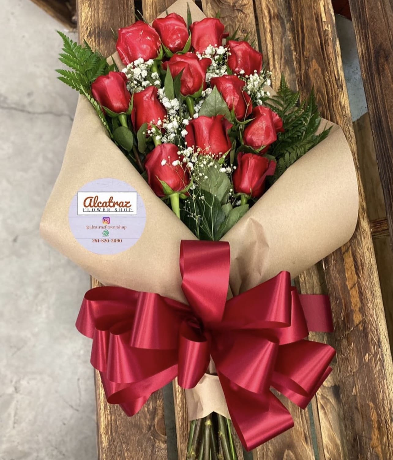 1 DOZEN RED ROSES FLAT 1 DOZEN RED ROSES FLAT - 1 DOZEN RED ROSES WRAPPED IN PAPER LAYING DOWN