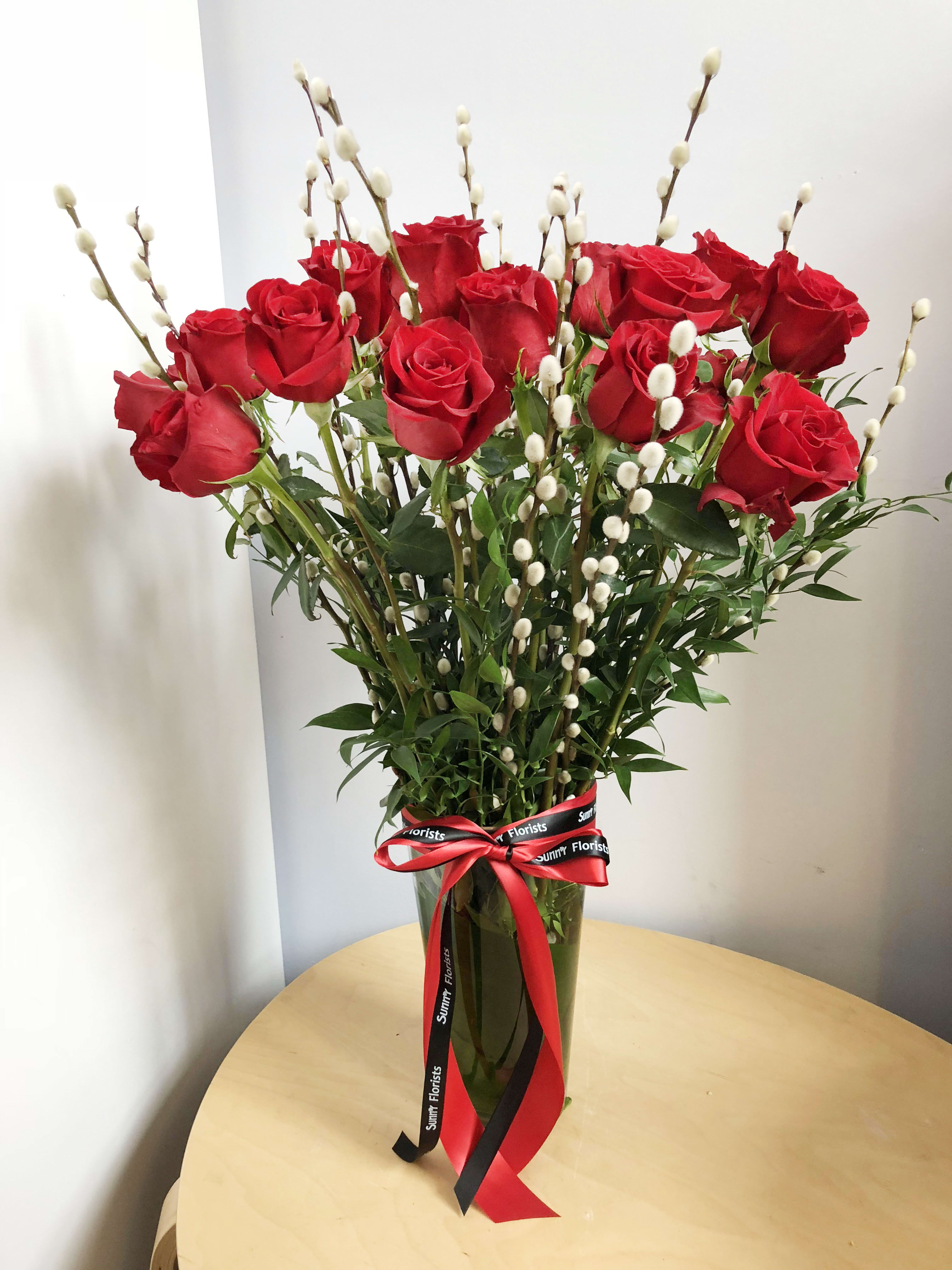 Long Stem Premium Dozen Rose Long Stem Premium Dozen Rose - This classy dozen rose arrangement is presented in a 11" tall glass vase.