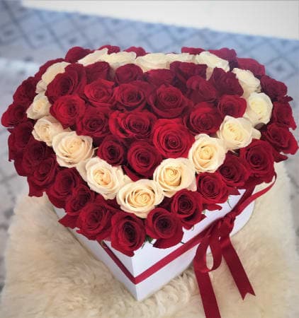 HEART BOX WITH WHITE OUTLINE - Capture The Essence Of Passion And Romance In This Beautiful Floral Design Of 60 Fresh Classic Red Roses With A White Rose Outline. This Arrangement Is Certainly Romance-Infused!