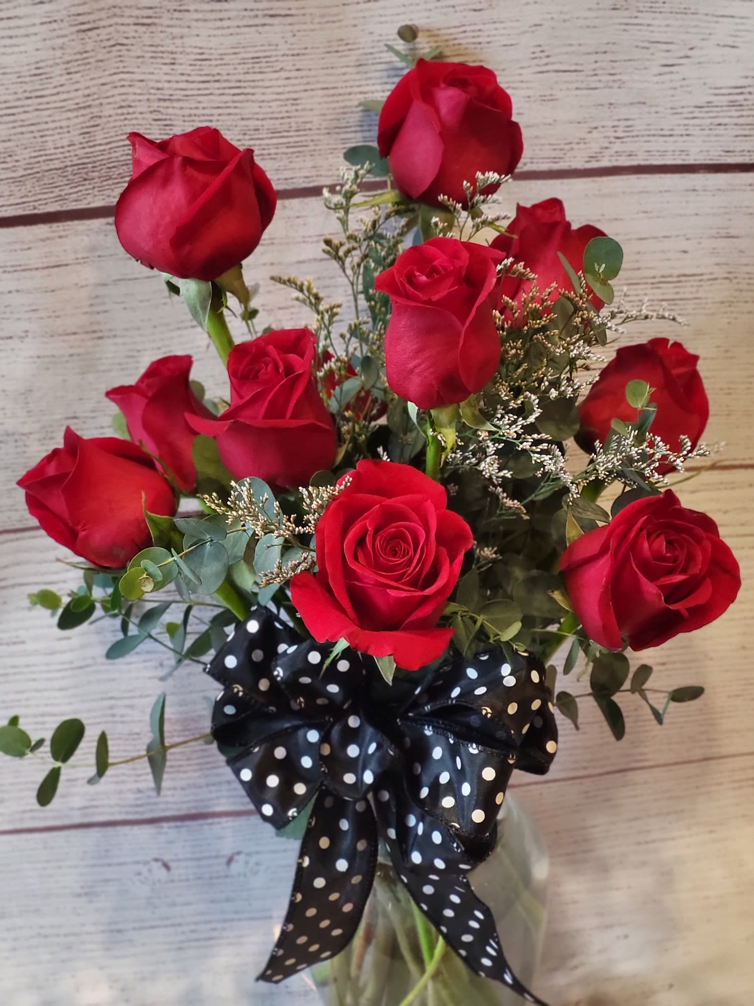Classic Dozen Red Roses - A charming bouquet of a dozen fresh and fragrant red roses, adorned with just a bit of greenery, is a classic Valentine’s Day gift. Delivered in a clear glass vase, this bouquet is also a romantic standard for any day of the year.